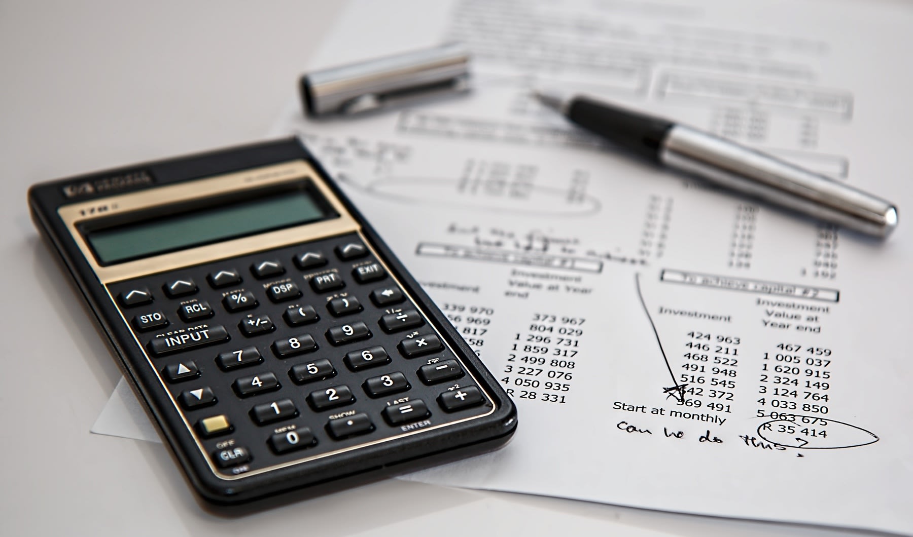 Calculator on top of printed document with data