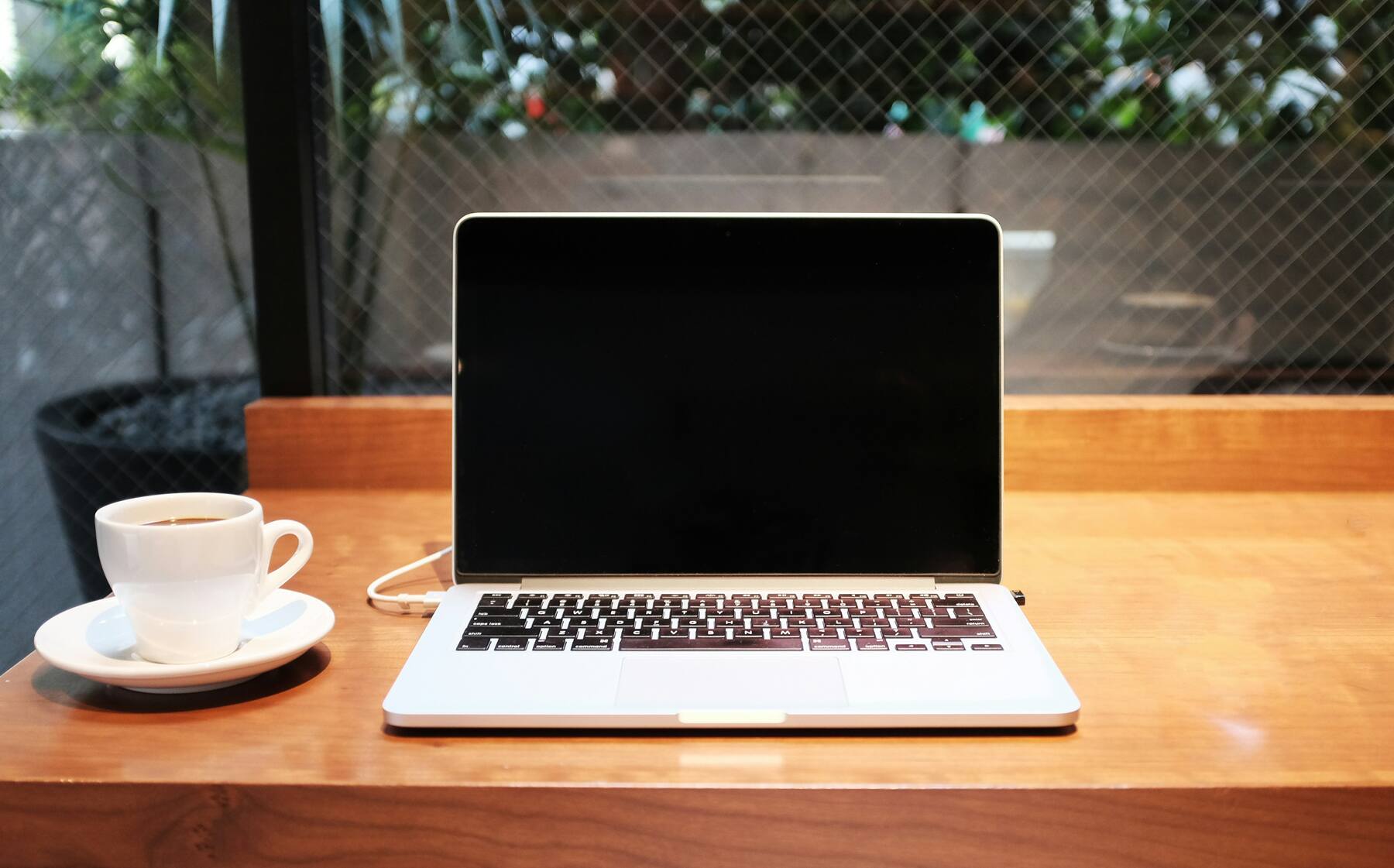 Laptop and coffee mug on top of a desk table