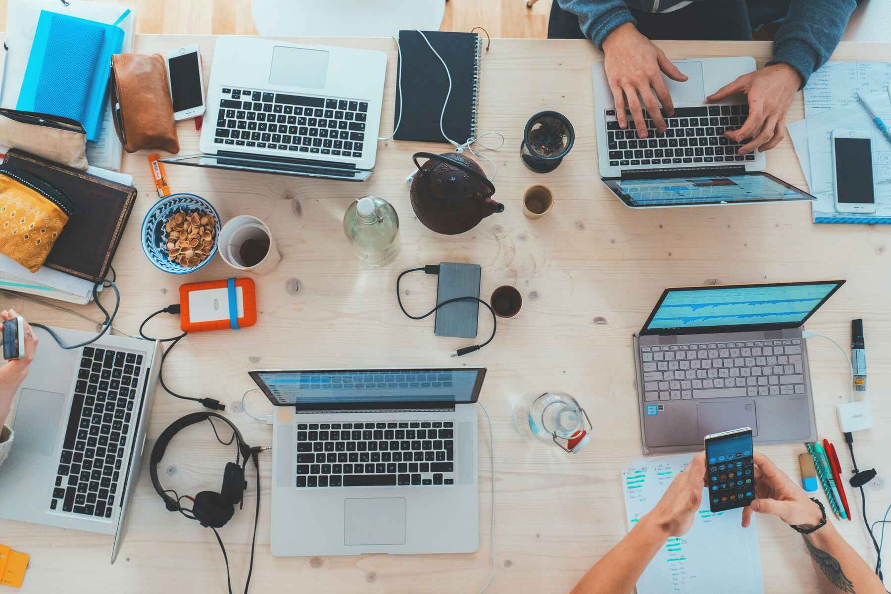 Several people using laptops on a table