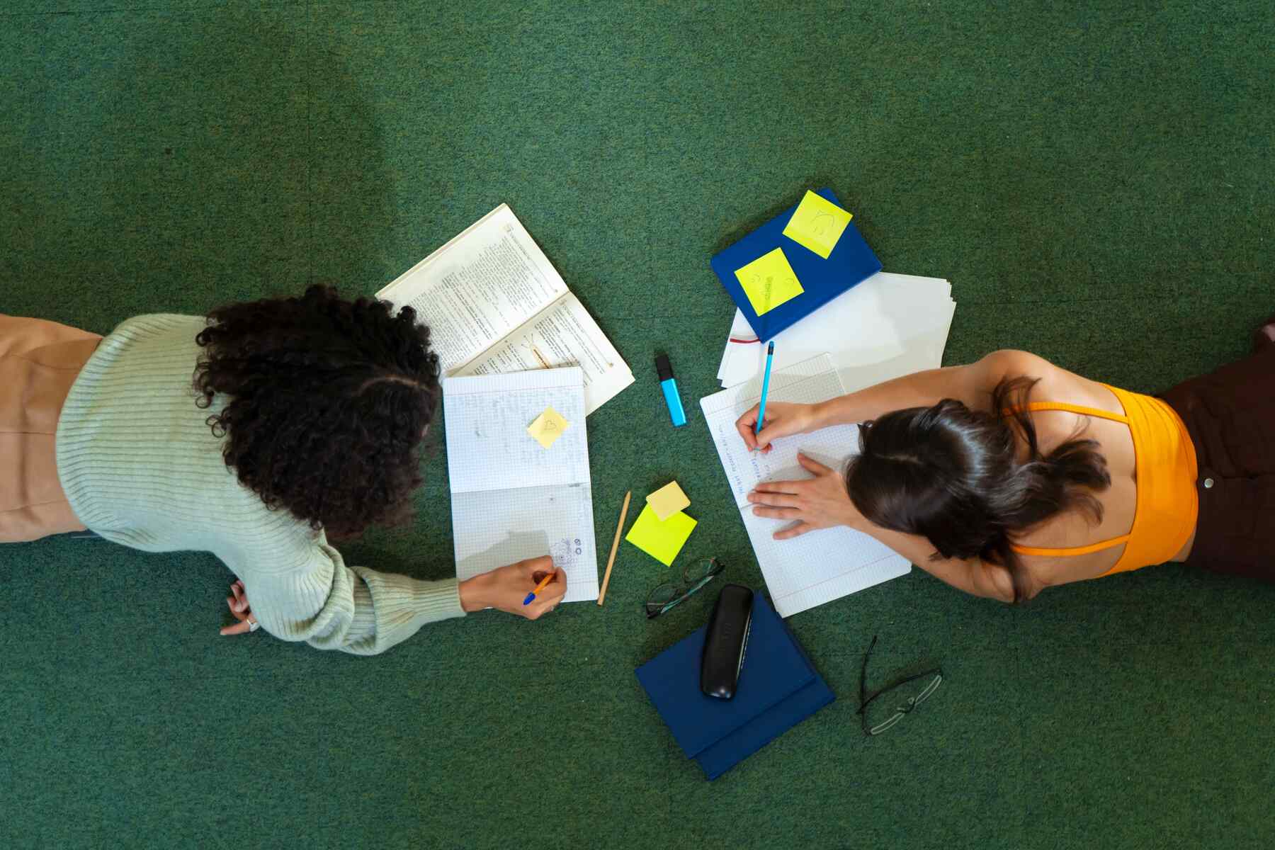 Two women studying on the floor