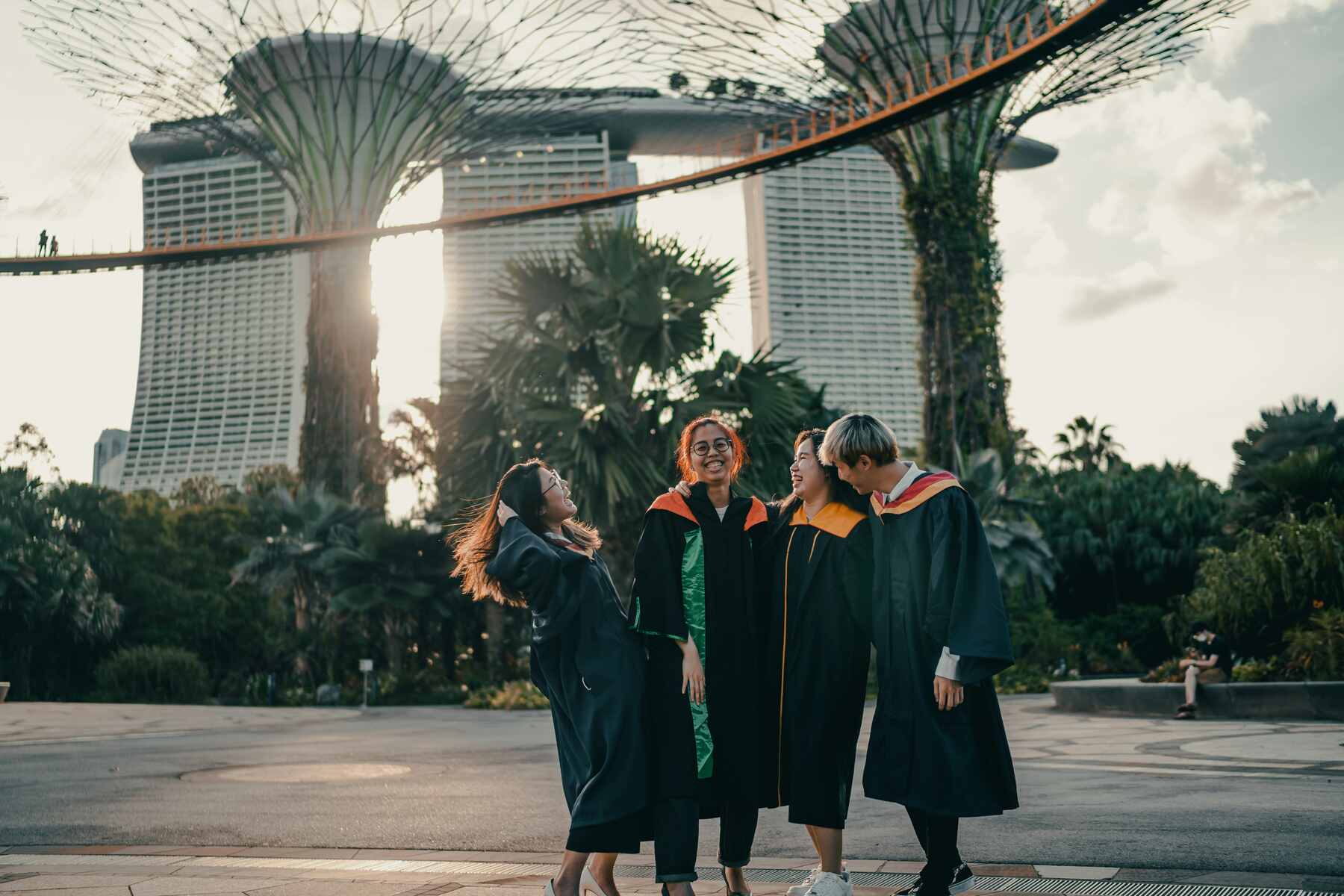 Four students posing together with their graduation robes and caps