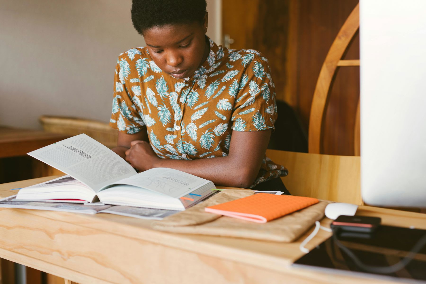 Woman reading a book in a school library