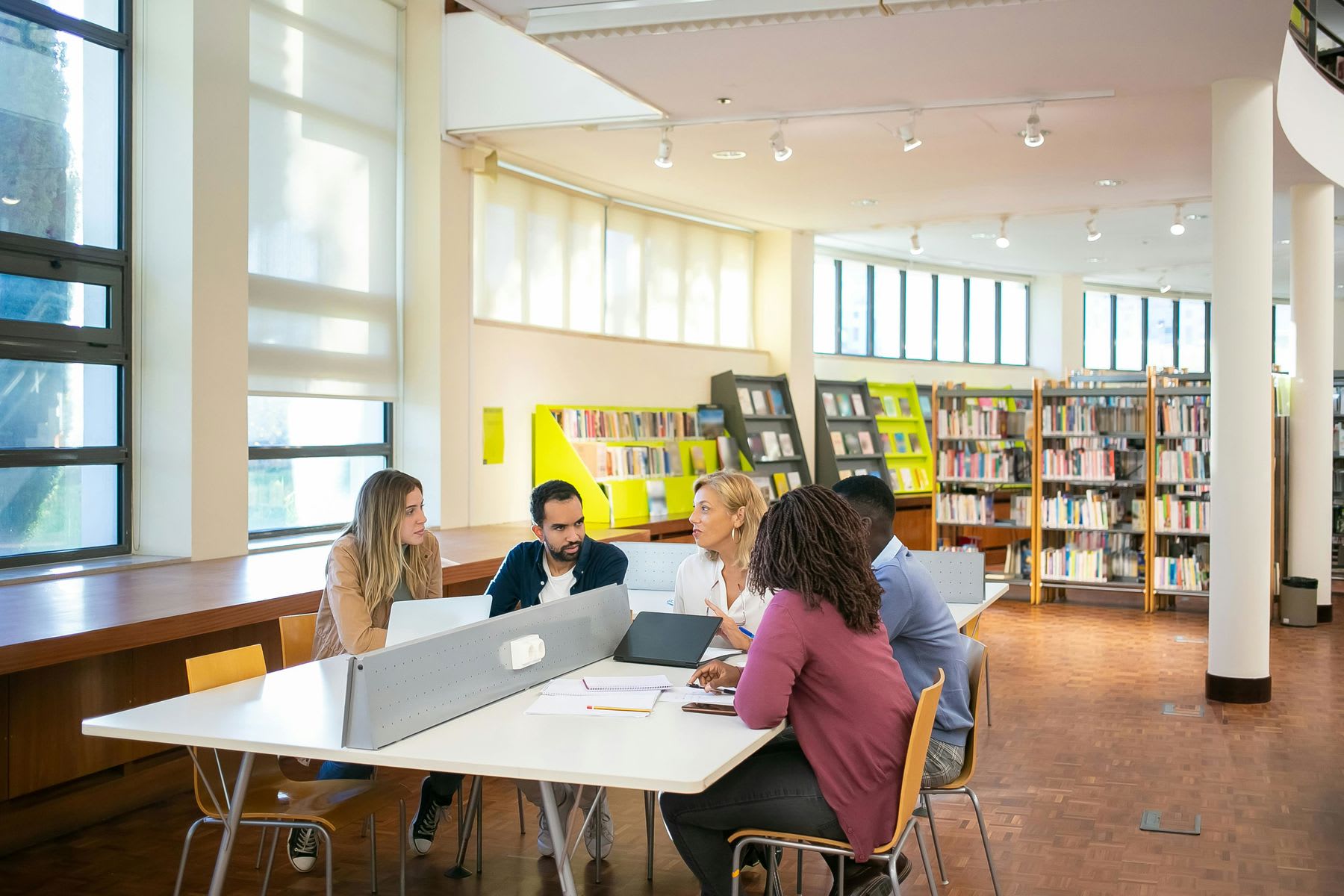 Students having a meeting inside a school library