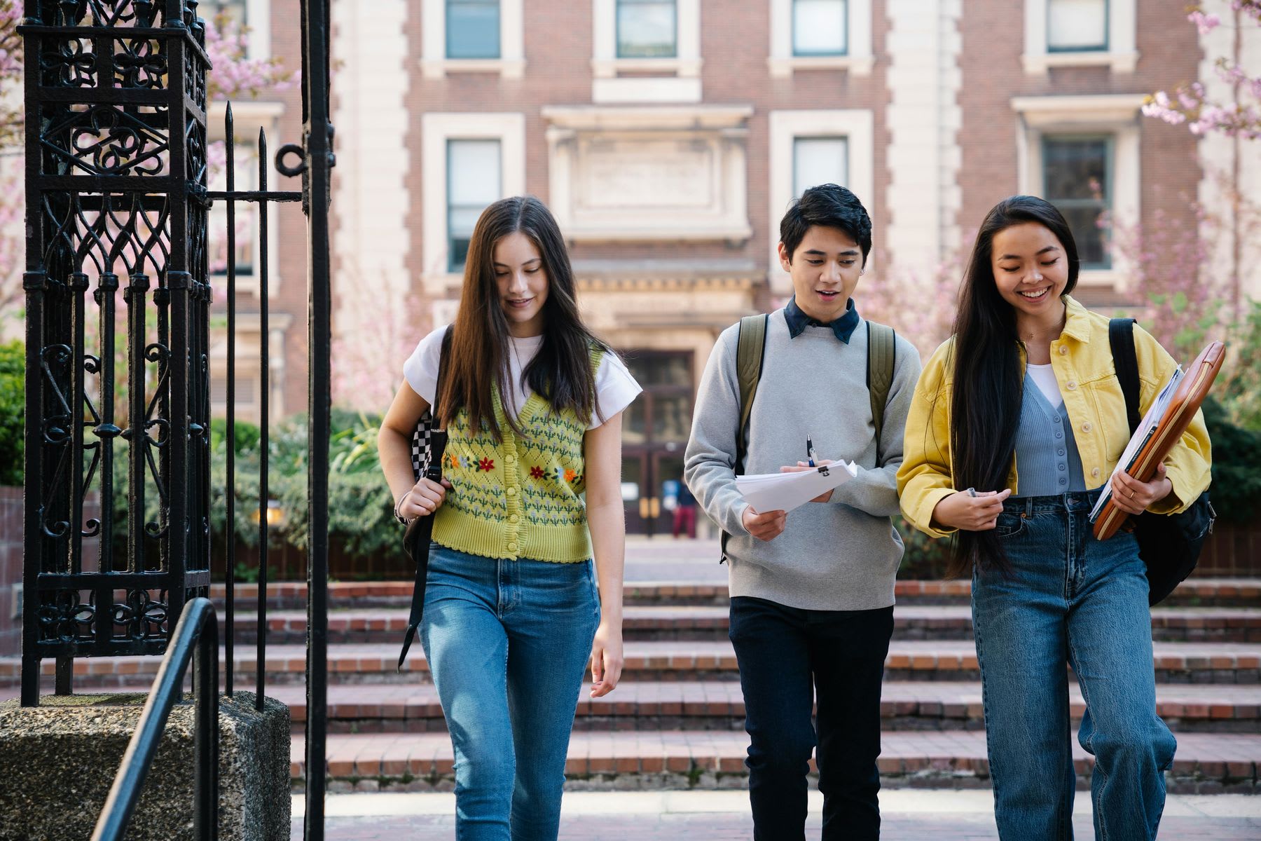 Students walking out of the gates of a university