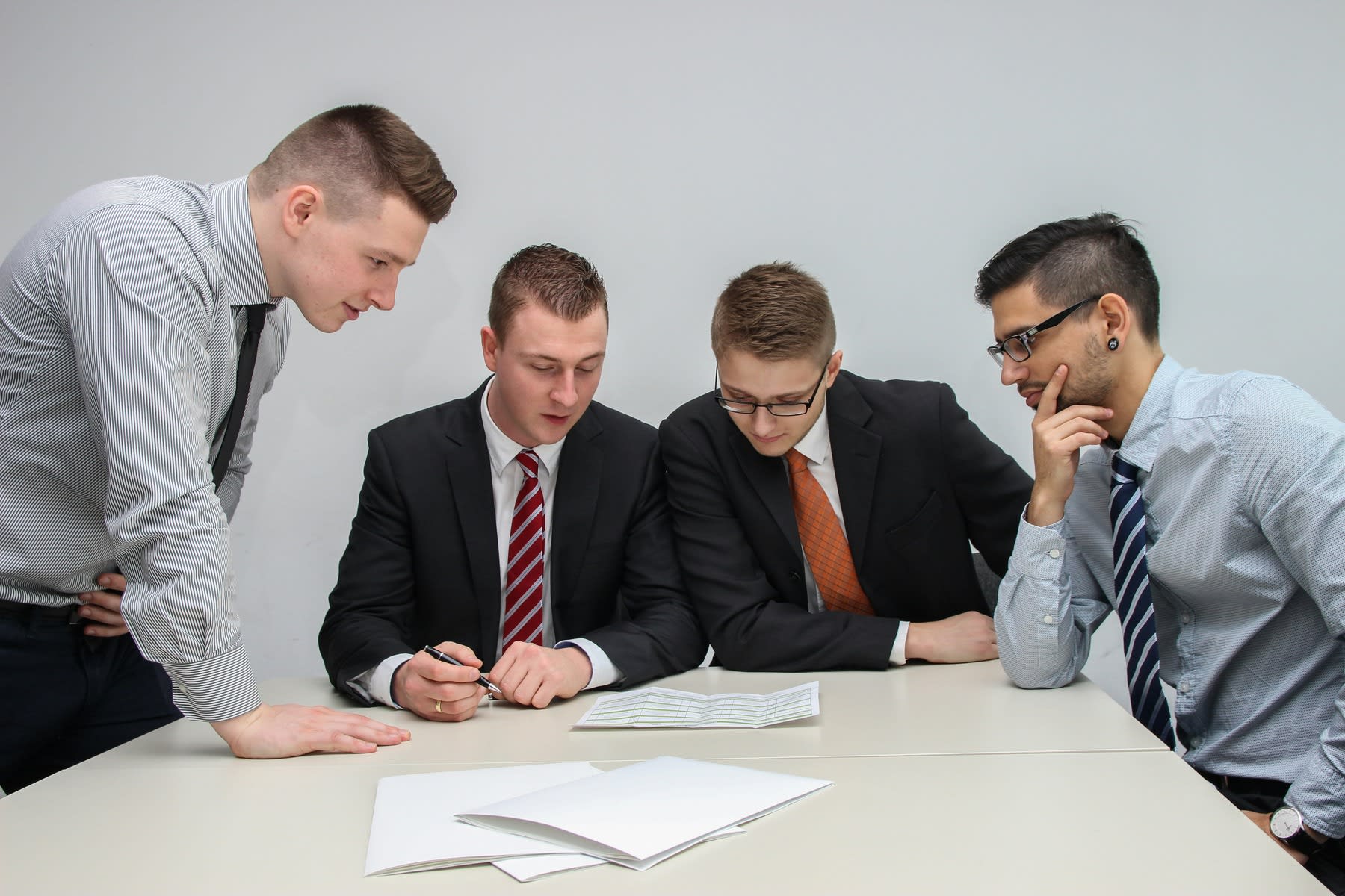 Students gathered on a table looking at a piece of paper