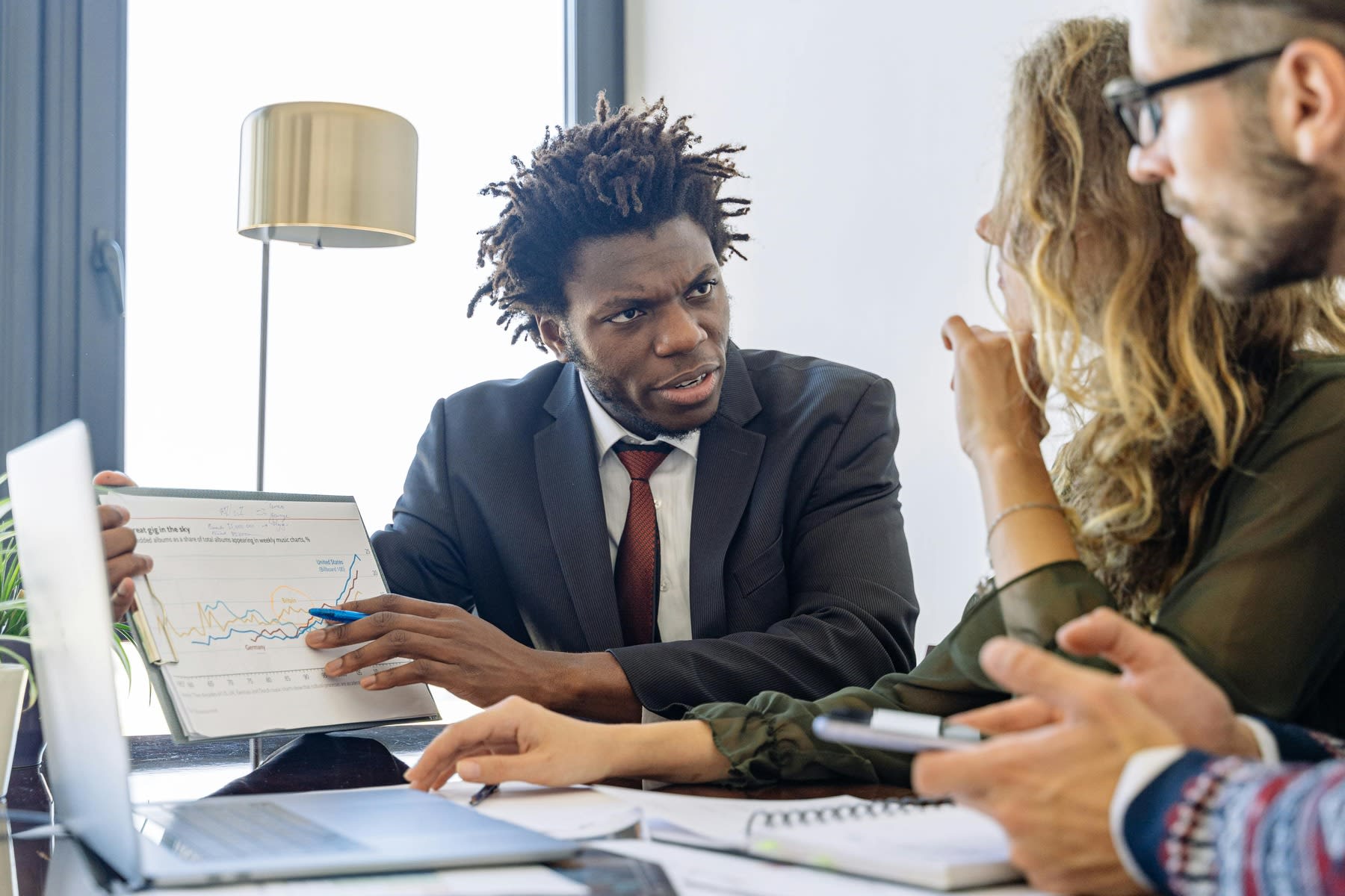 Man showing data reports to his clients