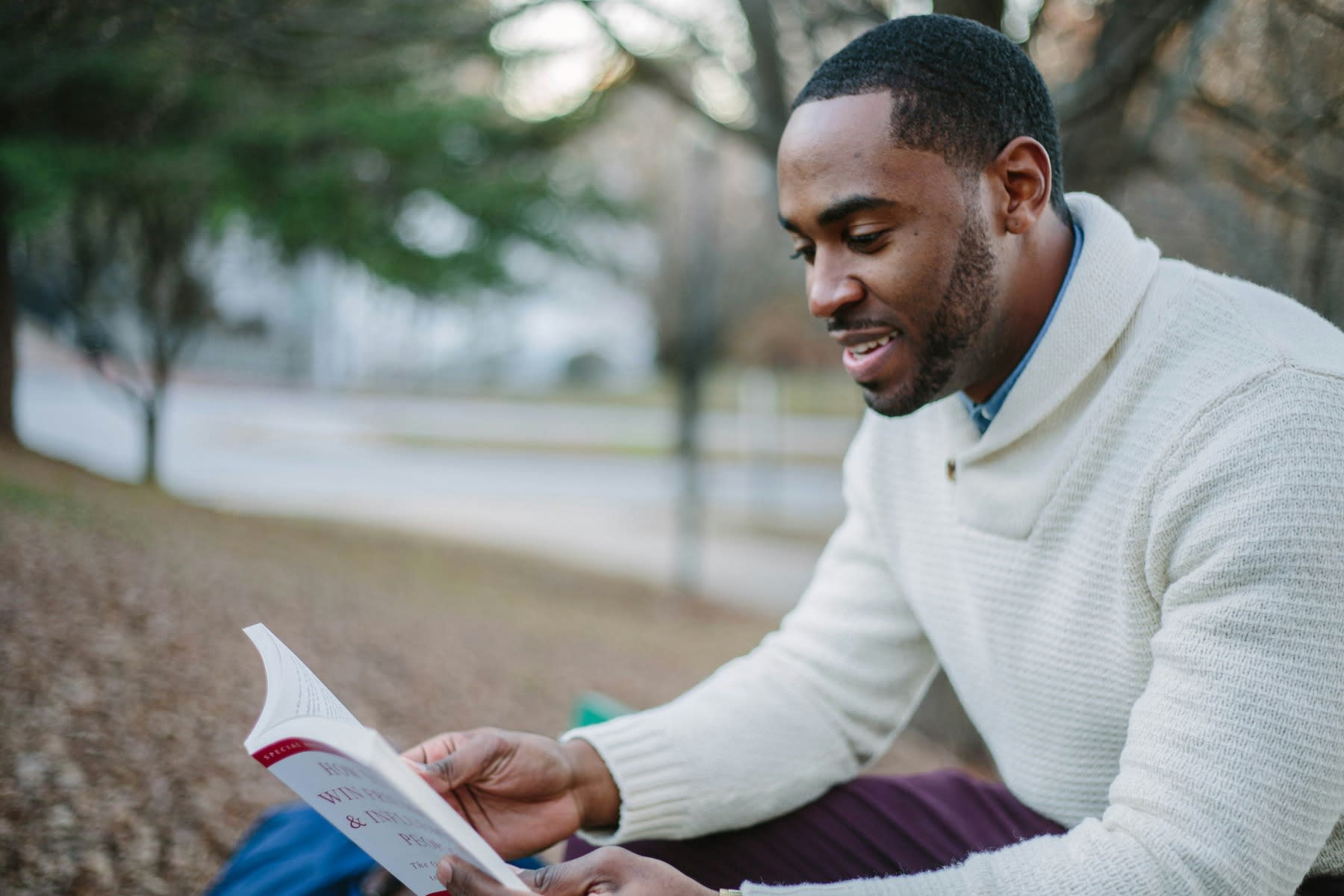 Man reading a book outdoors