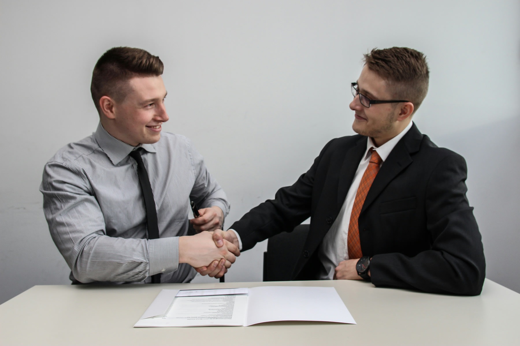Two men shaking hands after reaching an agreement