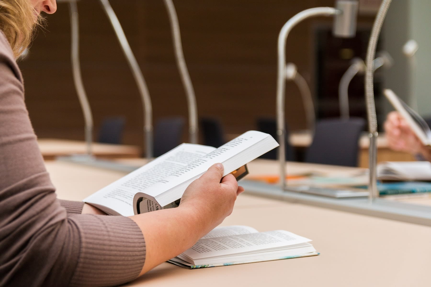 Woman reading a book in a public library