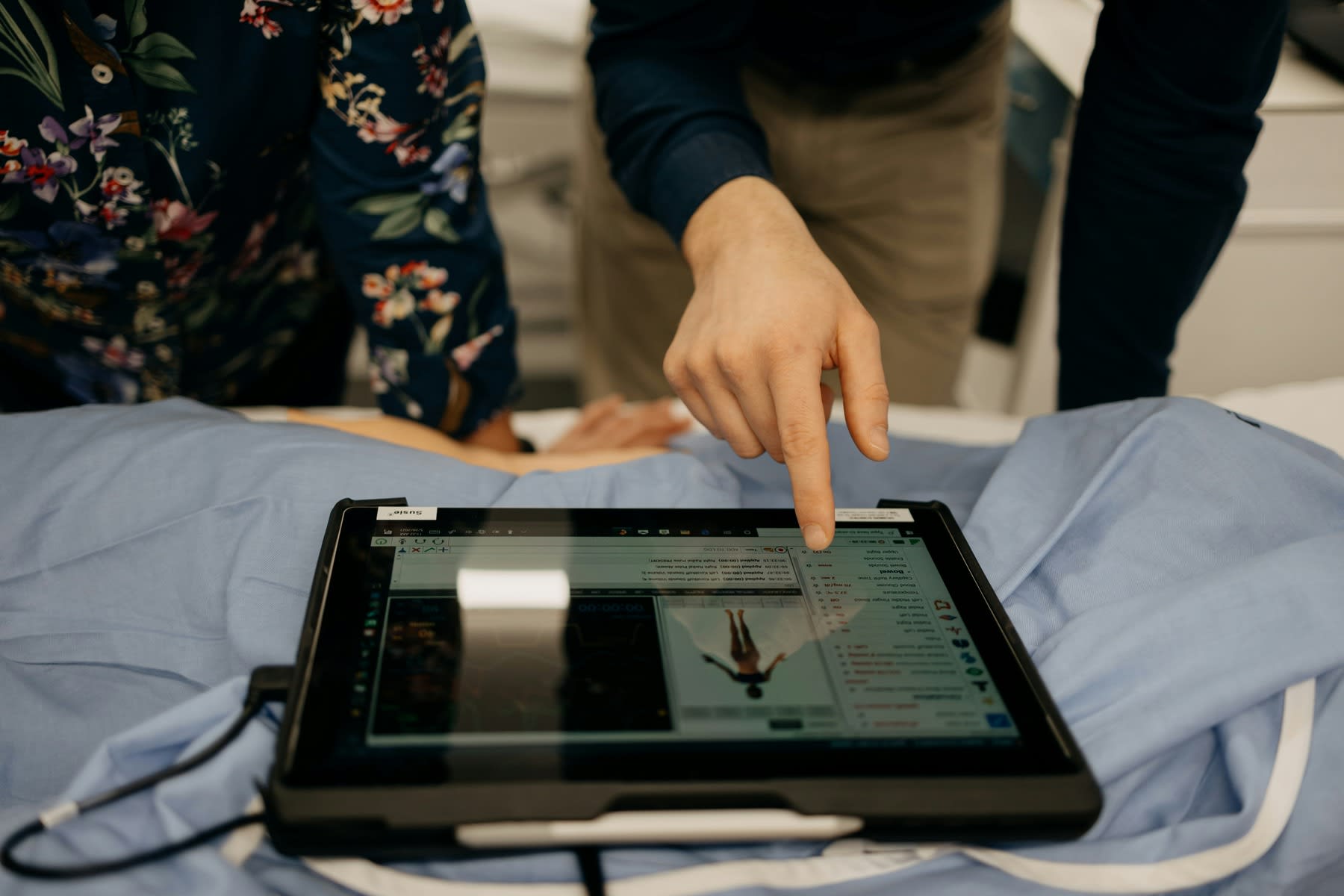 Man pointing to a tablet with medical information