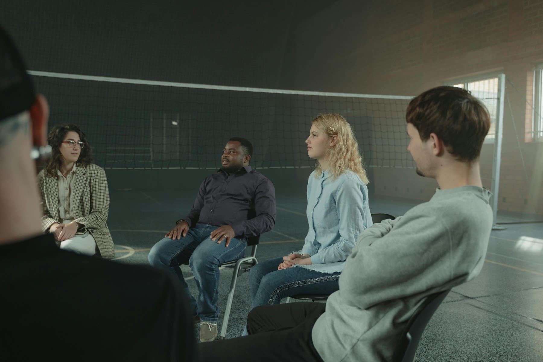 People sitting on a circle for a group therapy session