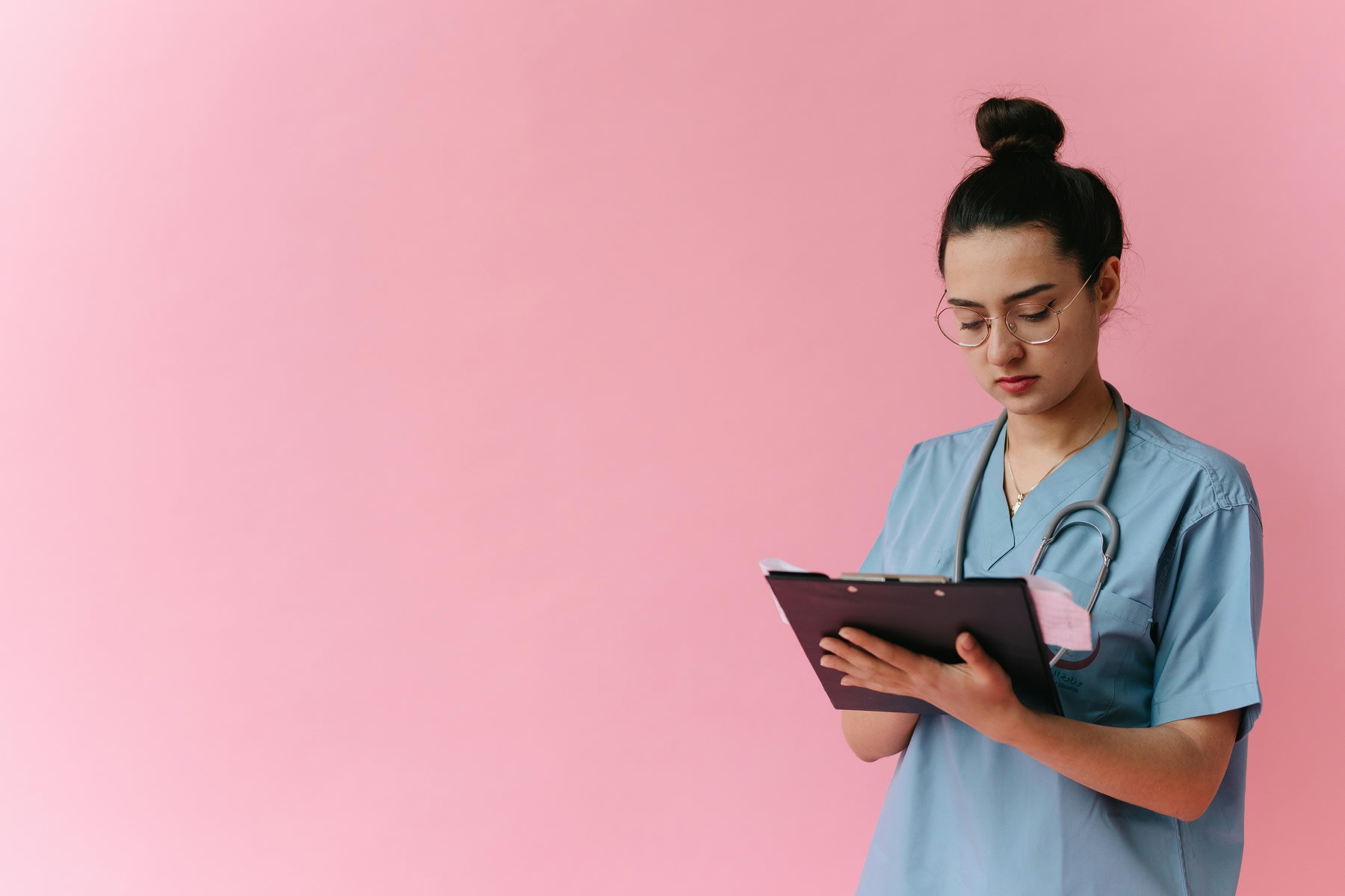 Nurse reading her clipboard