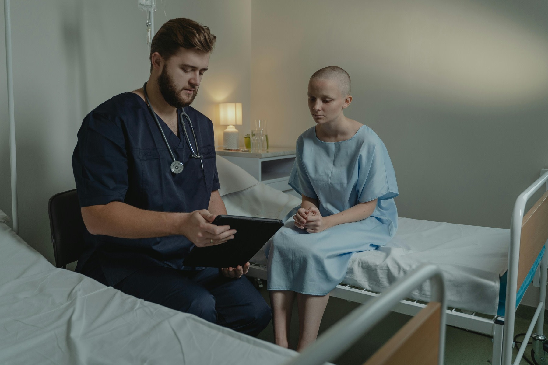 Nurse showing a tablet to his patient
