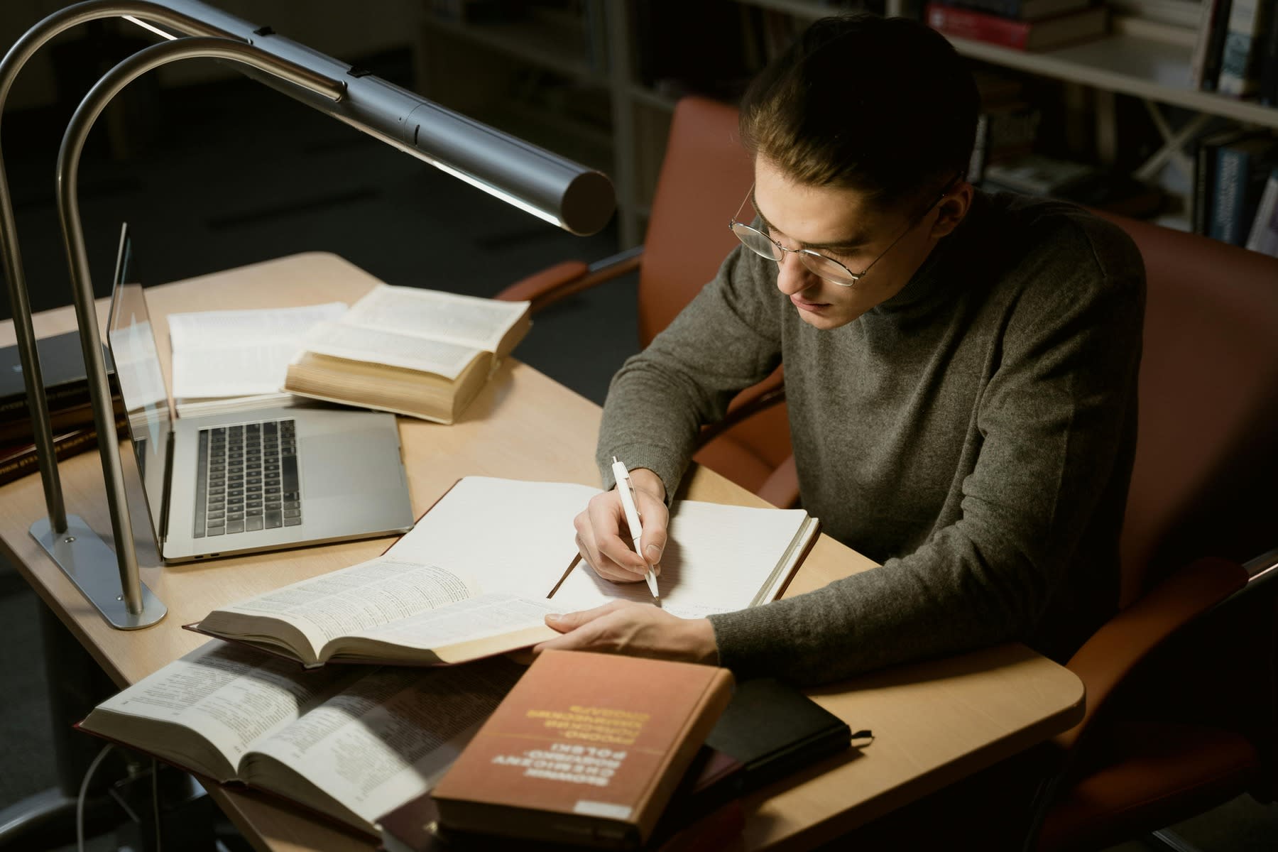 Man writing notes on his notebook