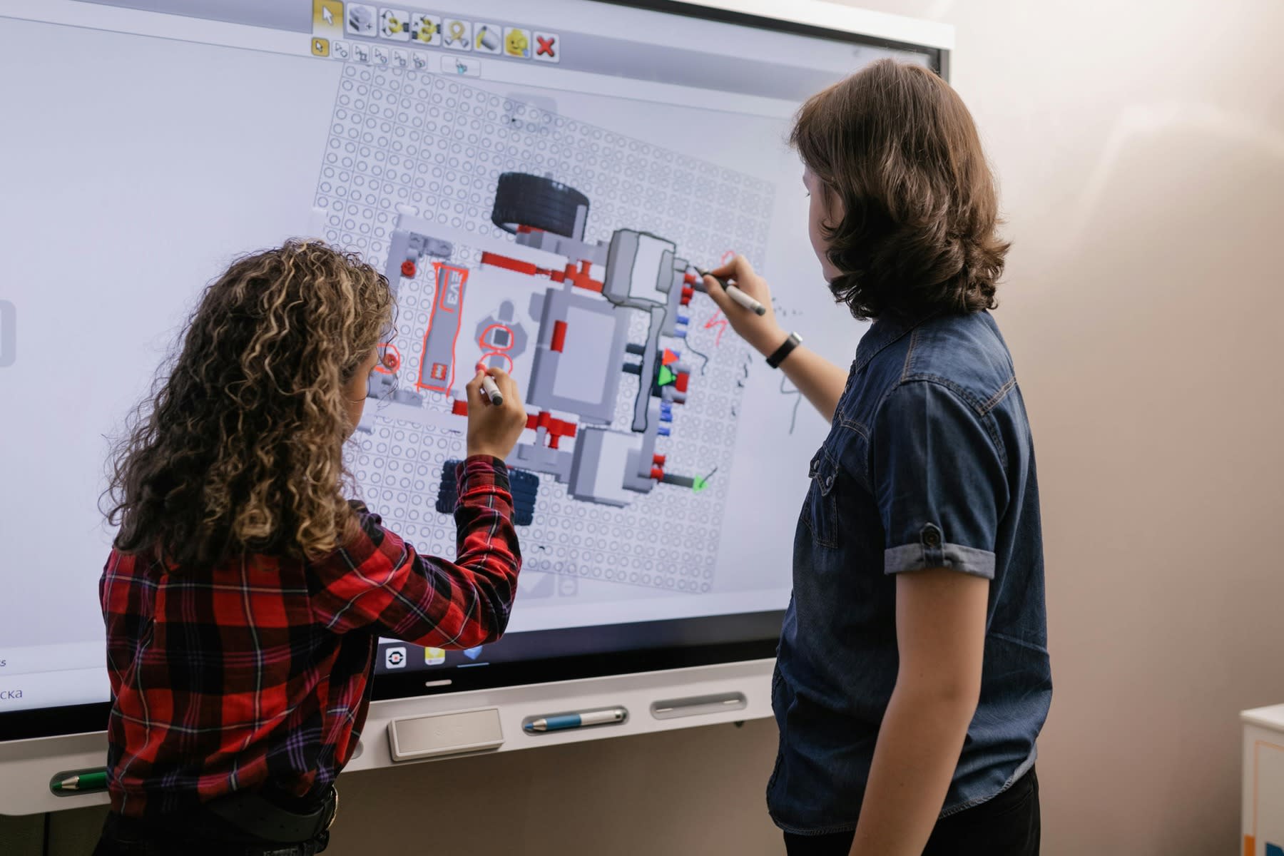 Students using an interactive board in a classroom setting