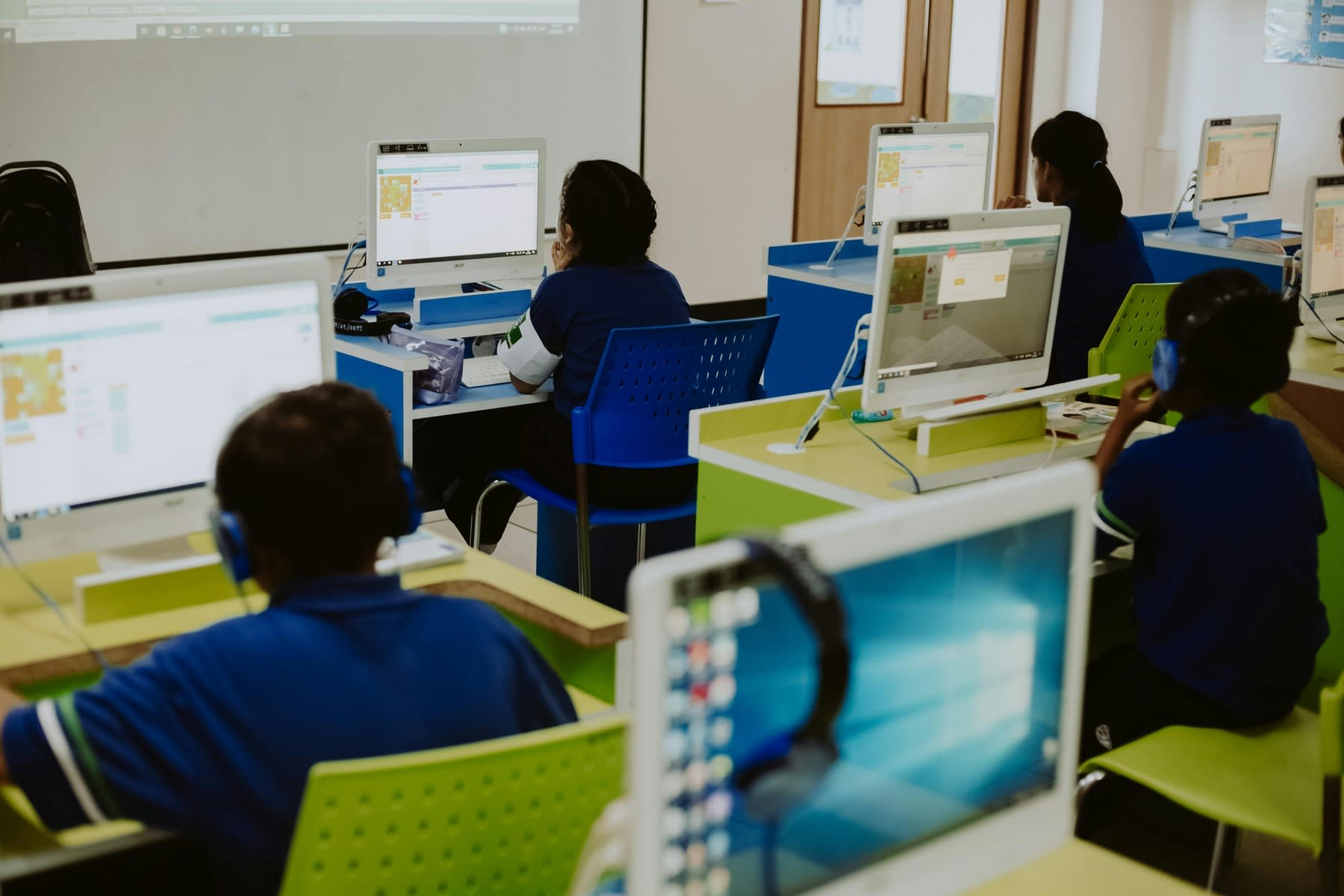 Students learning with computers on a classroom