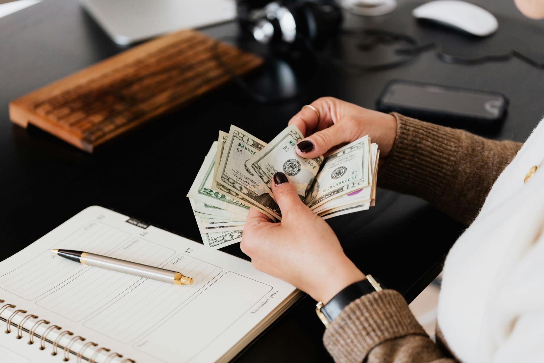 Woman counting dollar bills