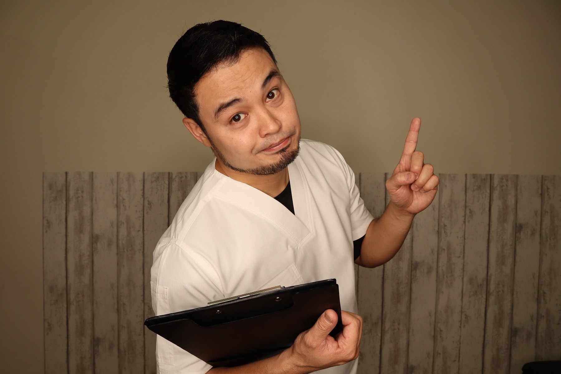 Male nurse holding a clipboard
