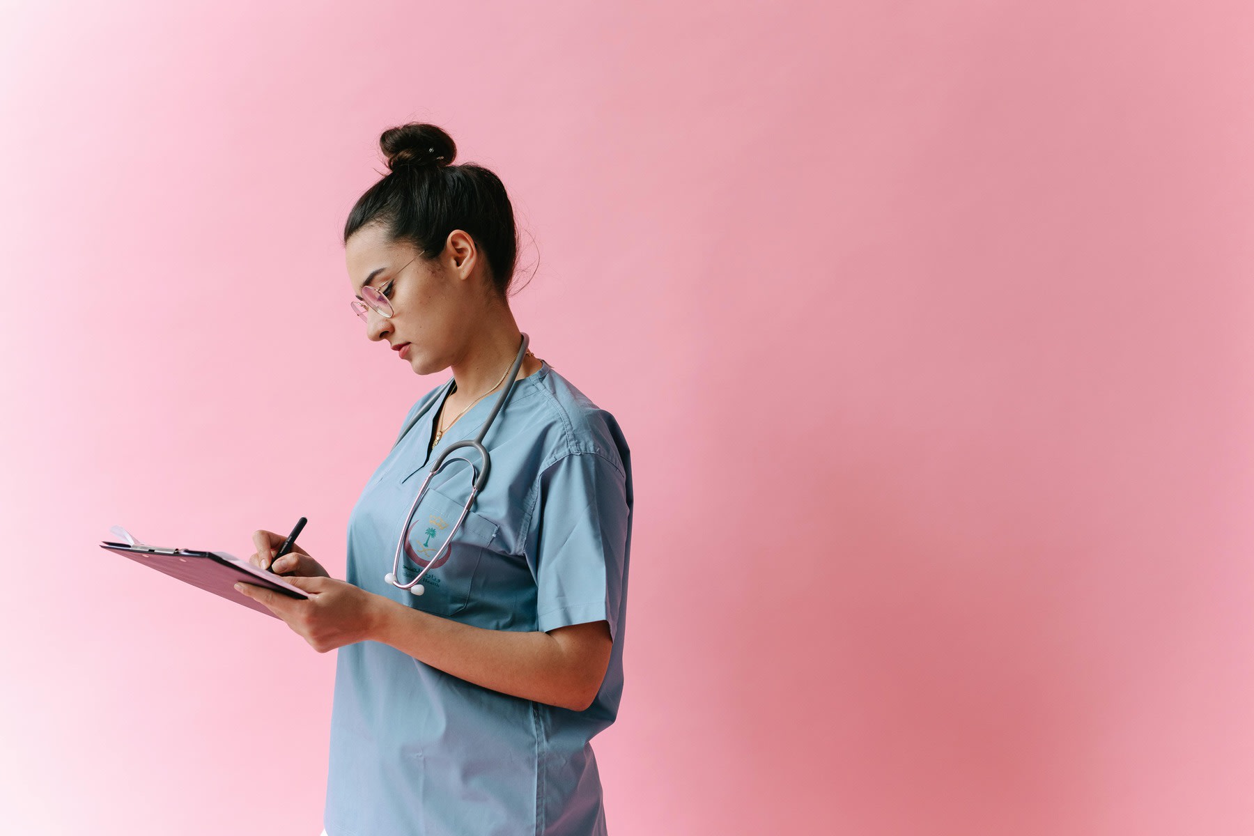 Nurse writing on a clipboard