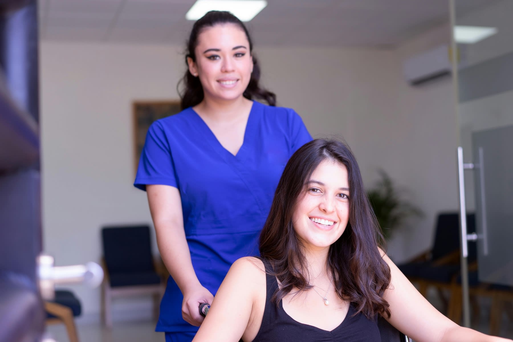 Female nurse pushing a patient's wheelchair