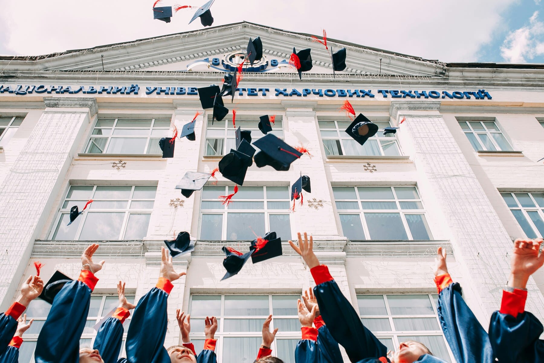 Graduate students throwing their caps in the air