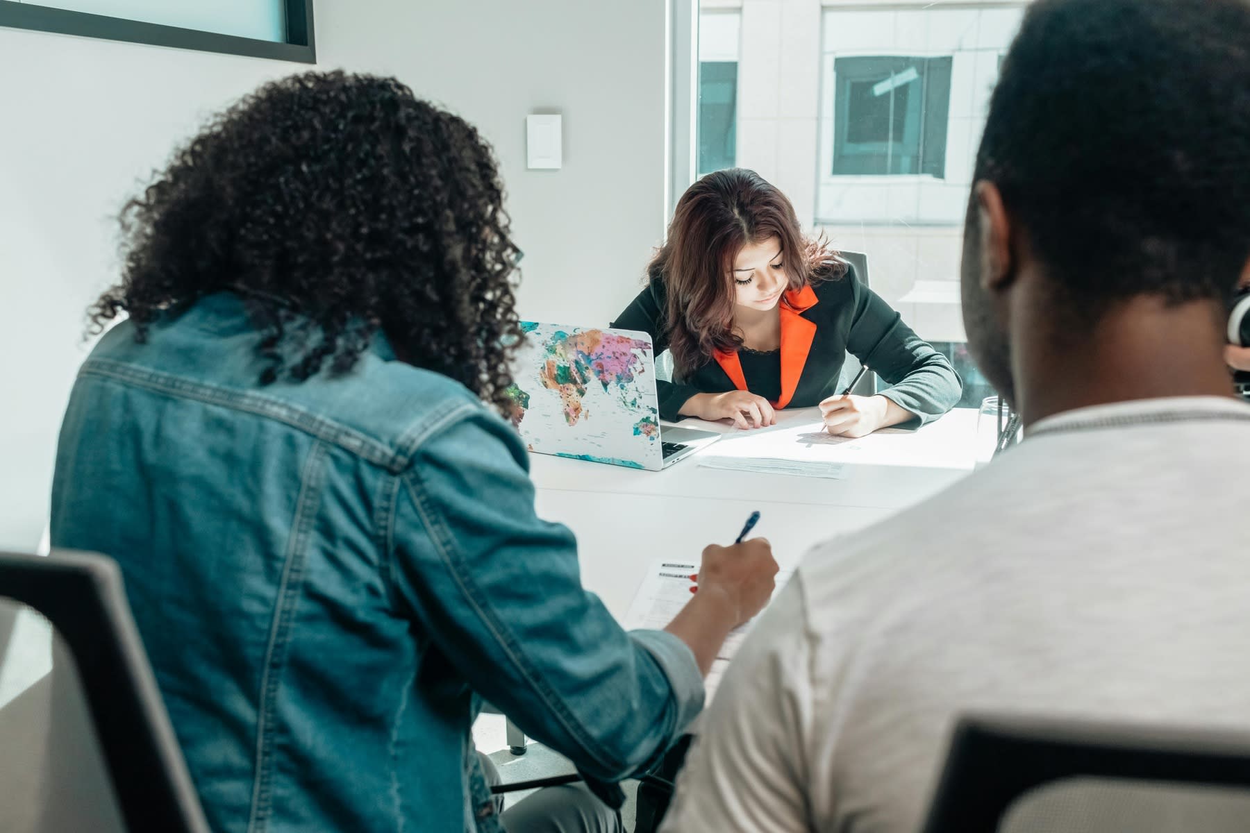 Students sitting in one table, while all are filling out forms