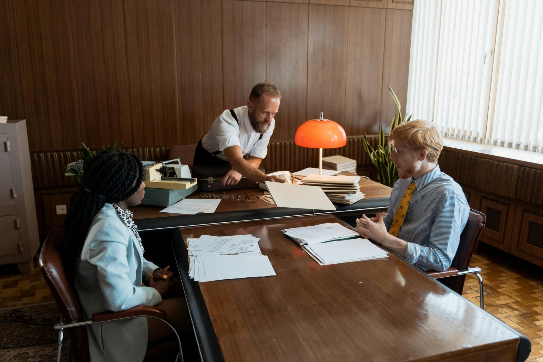 Young woman being interviewed by male executives