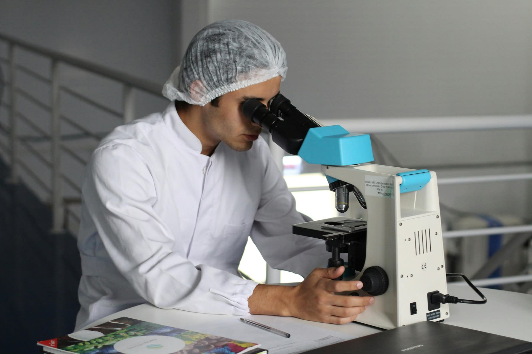 A biologist looking at the microscope