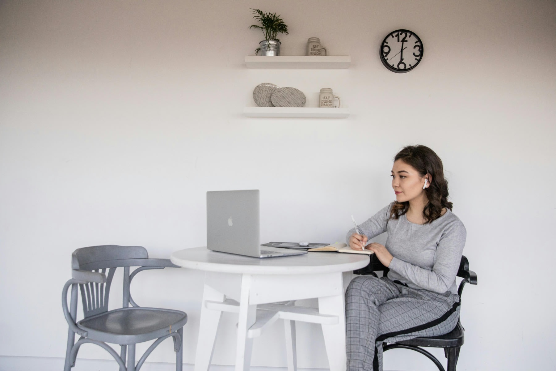 A woman sitting while studying online on her laptop