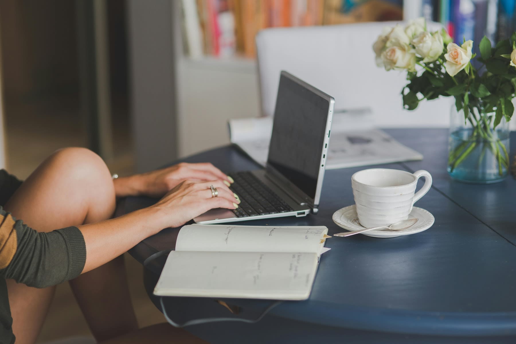 A woman typing on her laptop