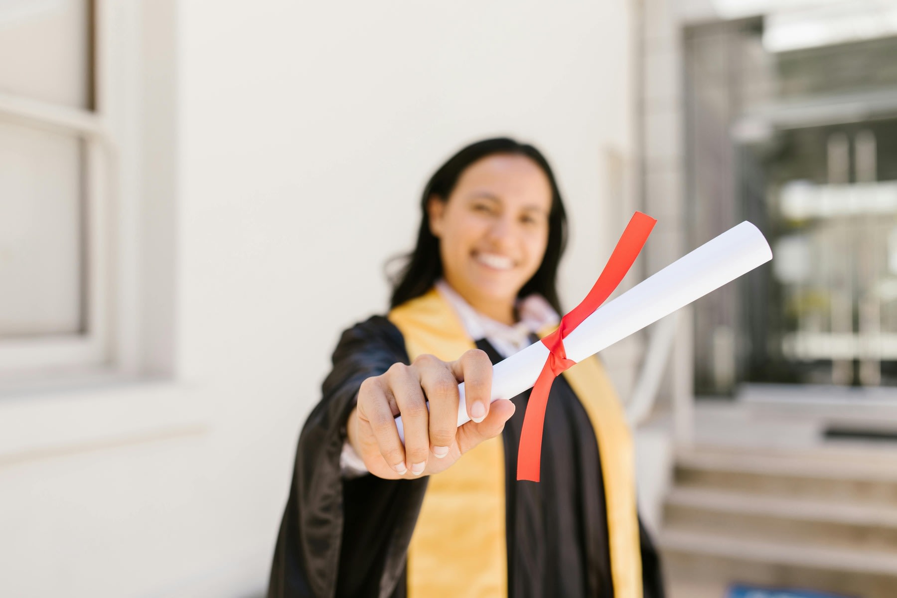 A woman showing her graduation diploma