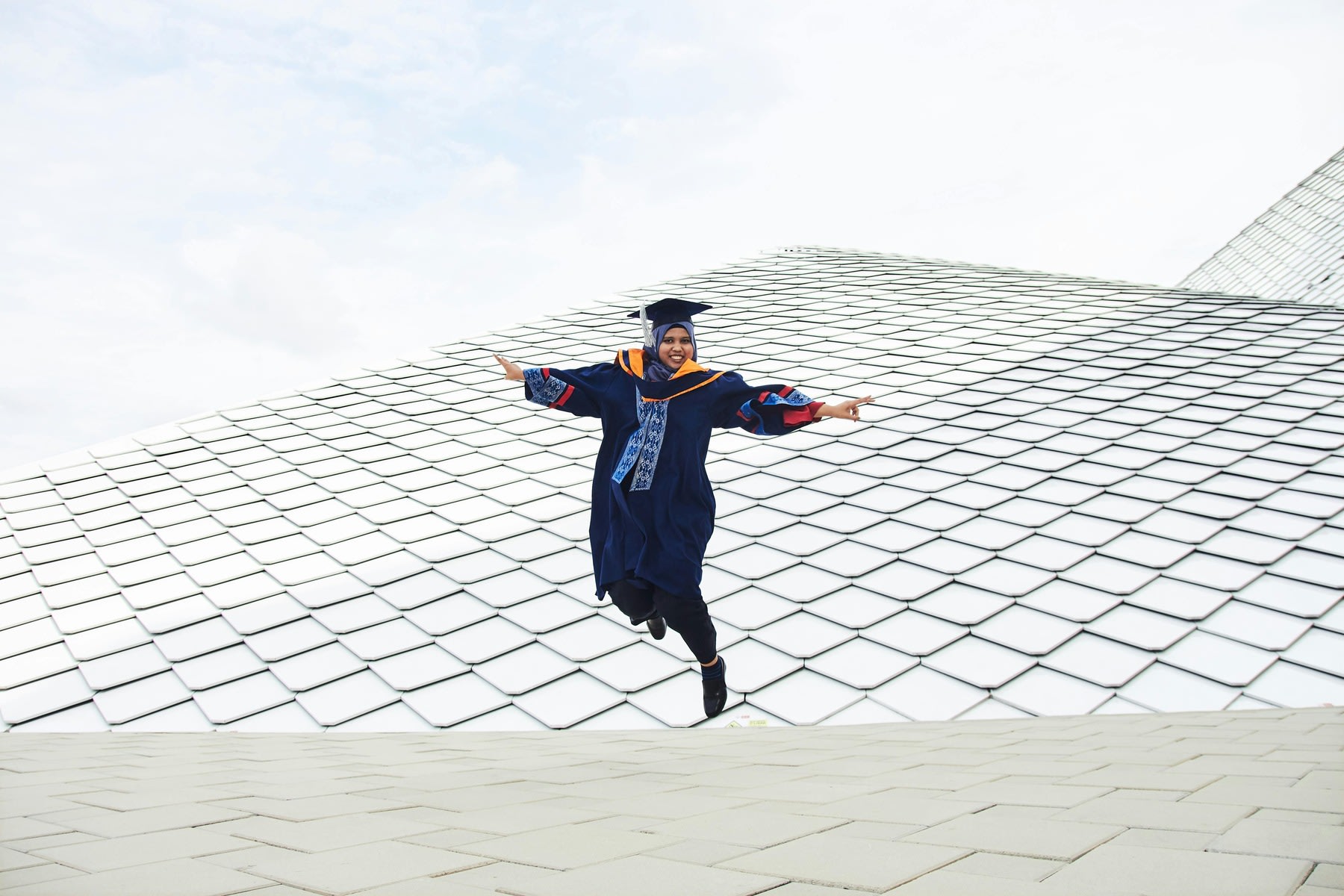 A woman happily celebrating her graduation day
