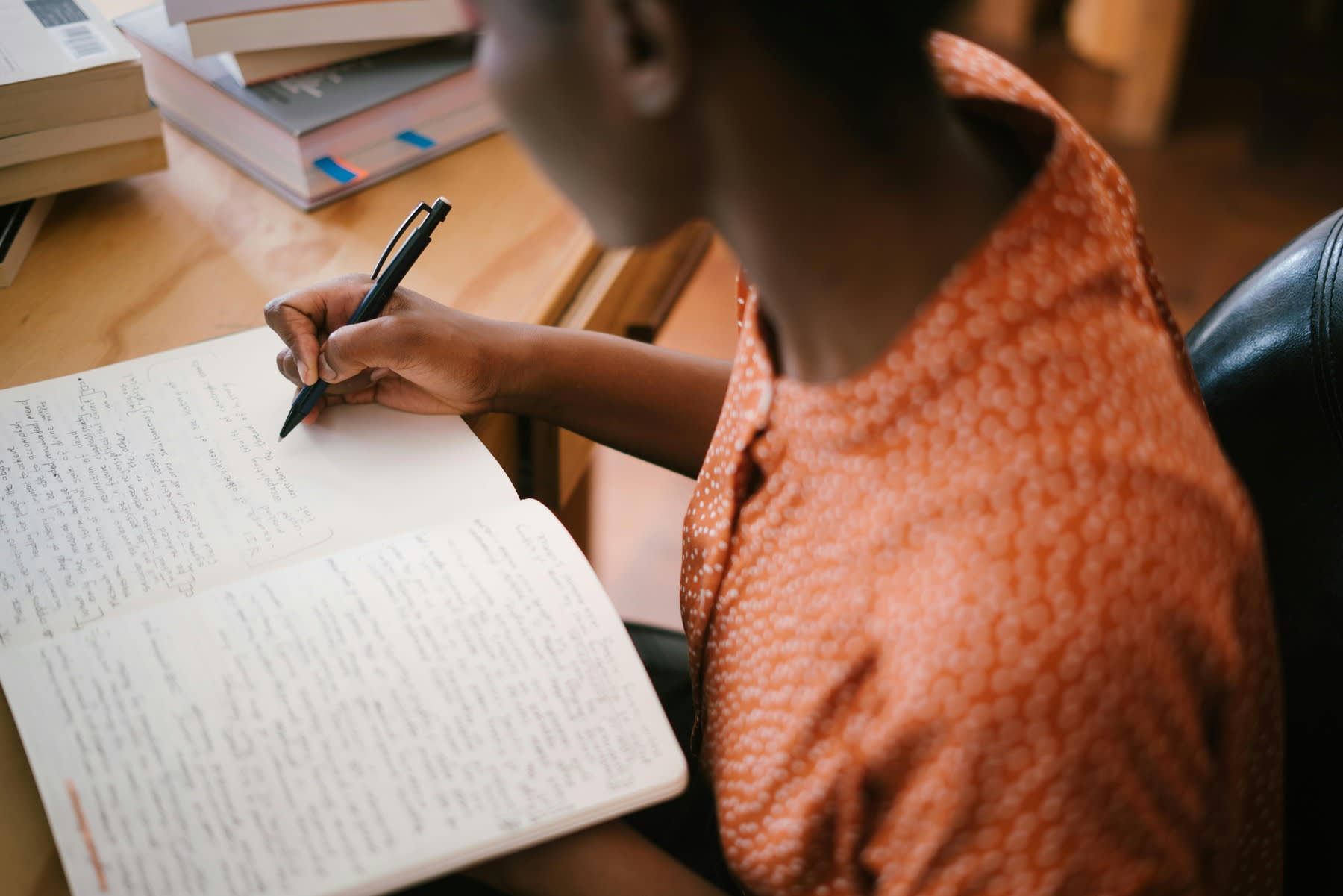 Woman writing notes on her notebook