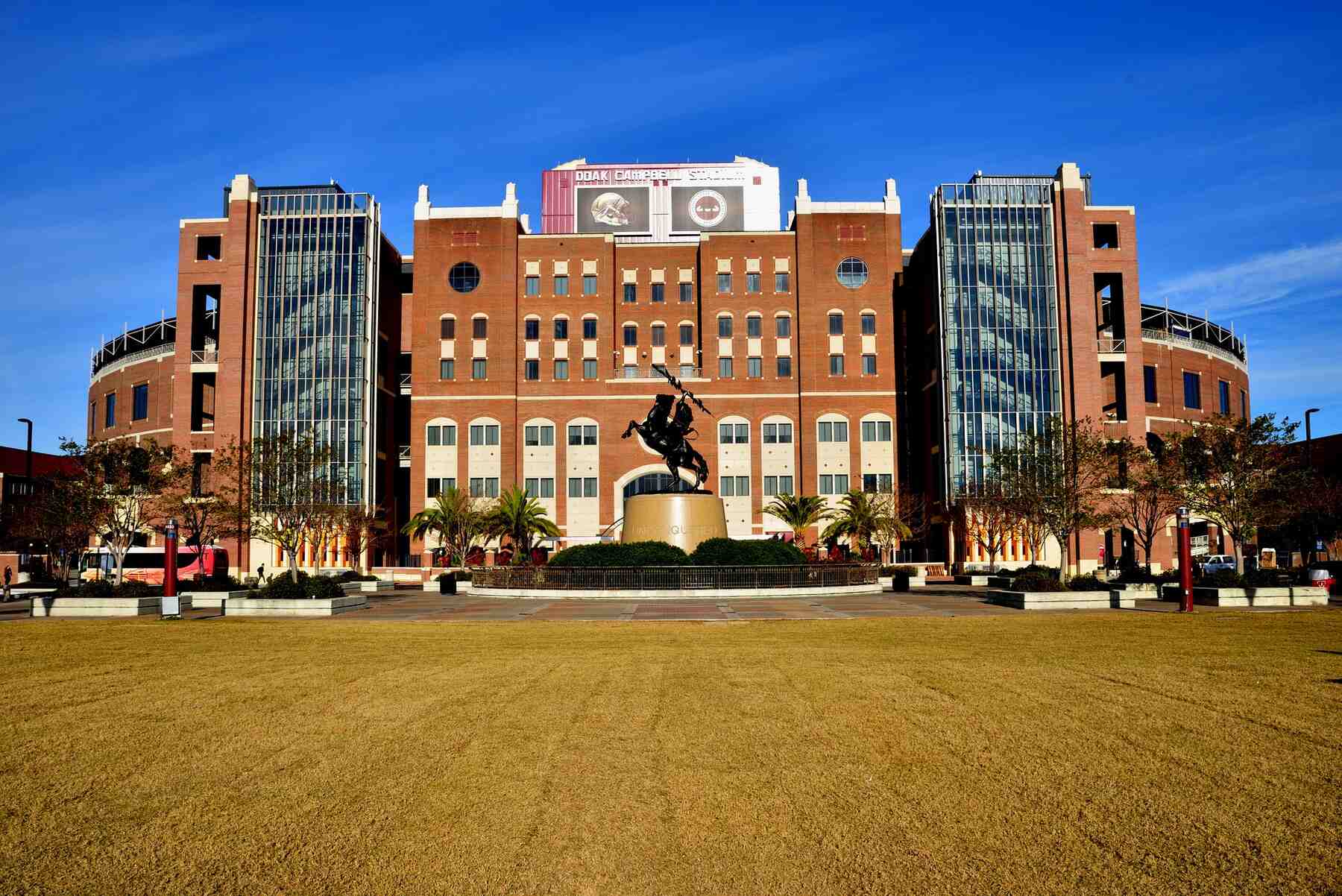 Grassy field in front of the Florida State University stadium on a sunny day