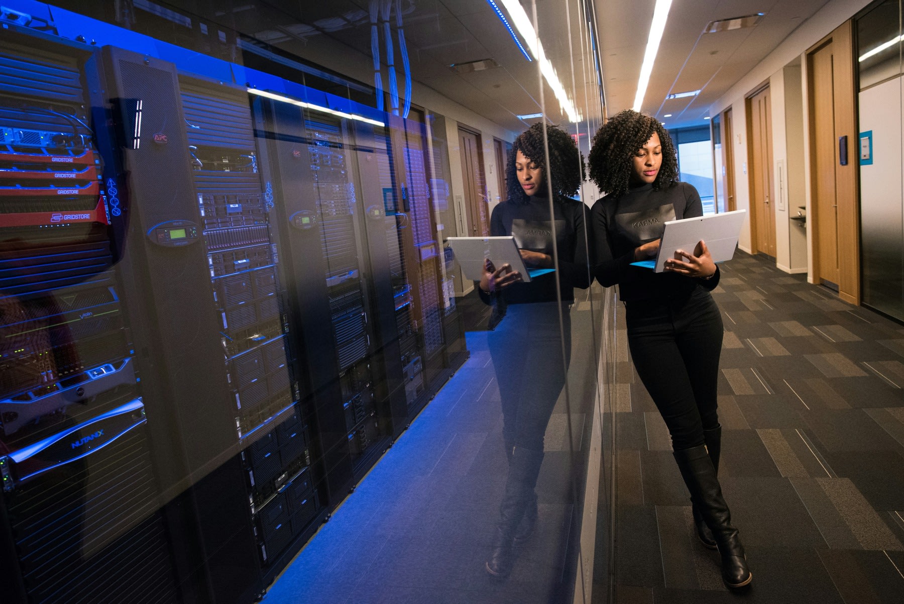 Woman standing beside the company's servers