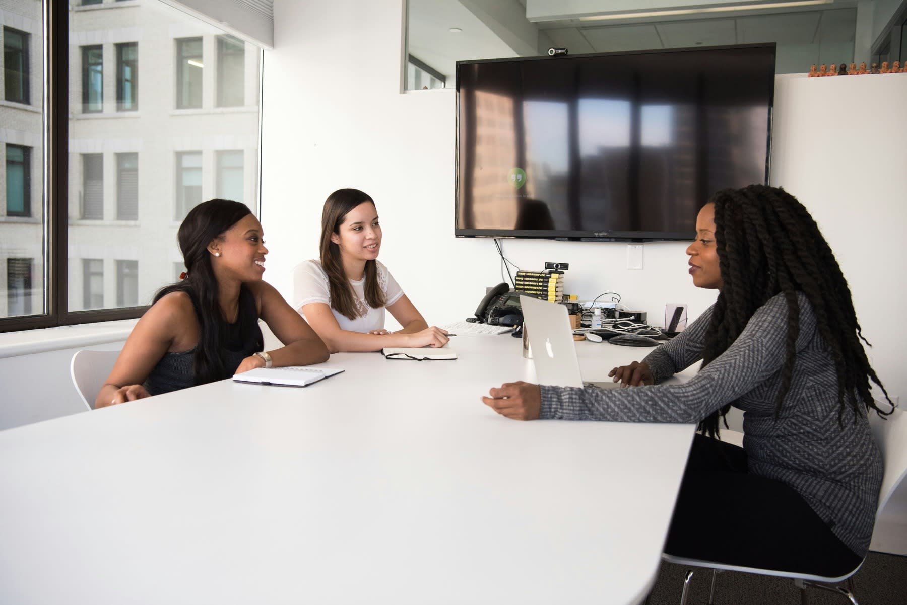 Employee having a meeting with an HR manager and an executive