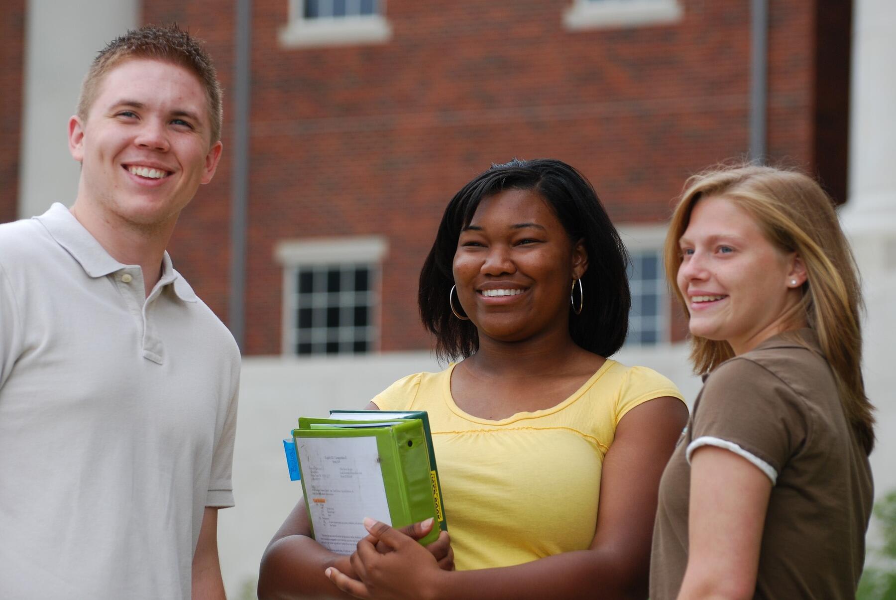 Students smiling in a college campus