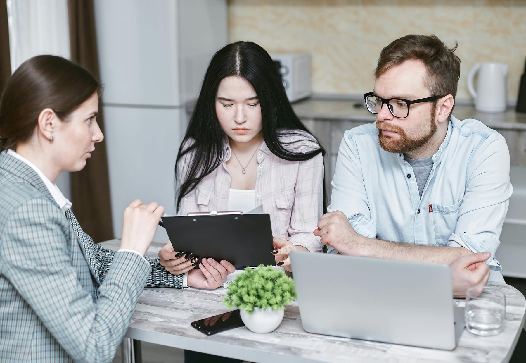 Couple listening to their financial advisor as she explains her report