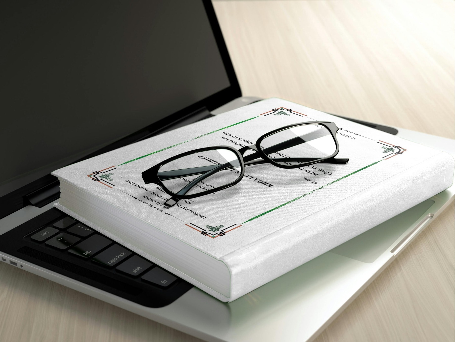 A laptop with a notebook and eyeglass on top