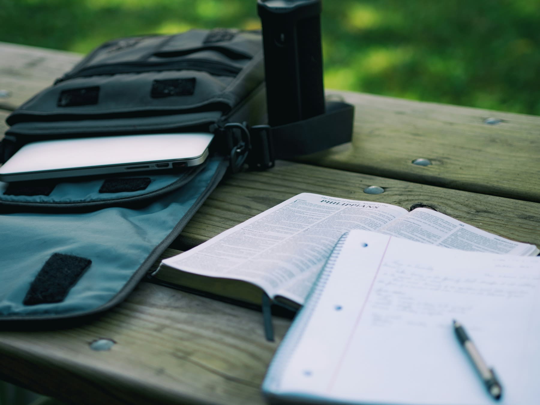 Opened bag with books and notebook on a table