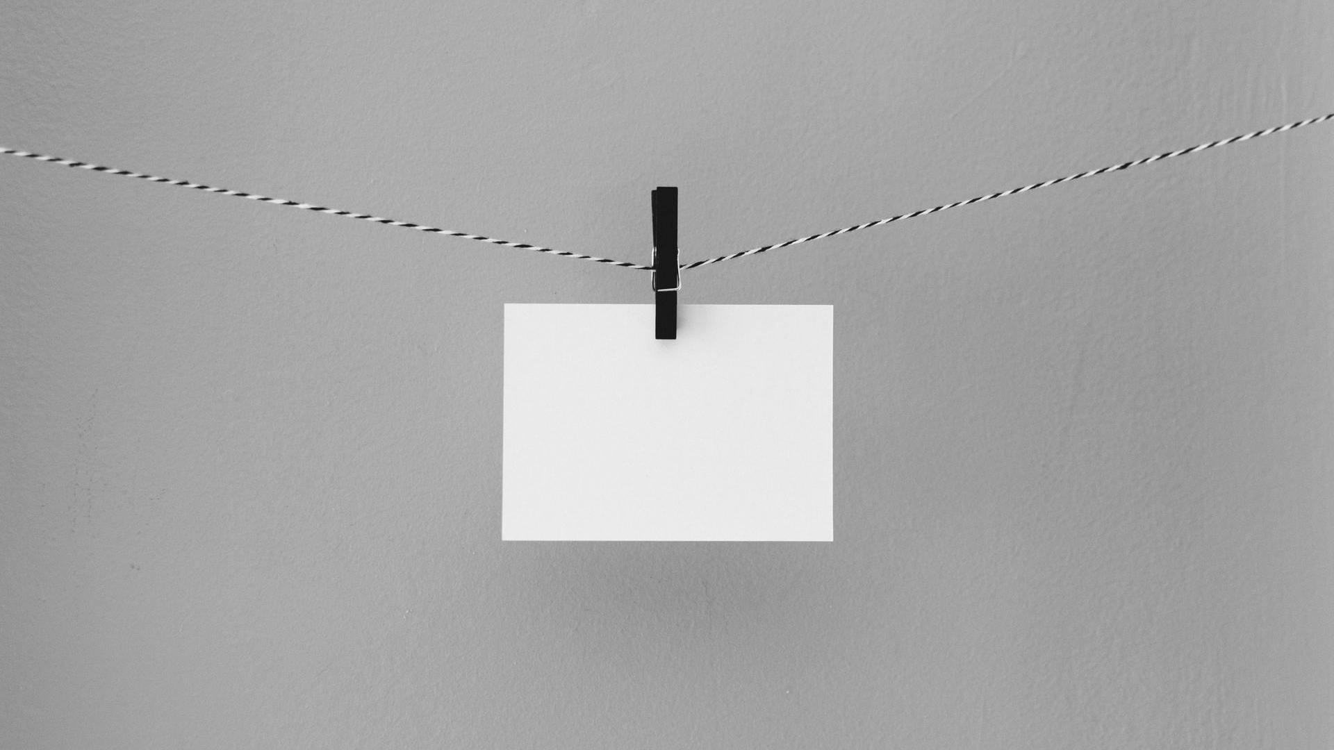 A single notecard hanging by clothes pin