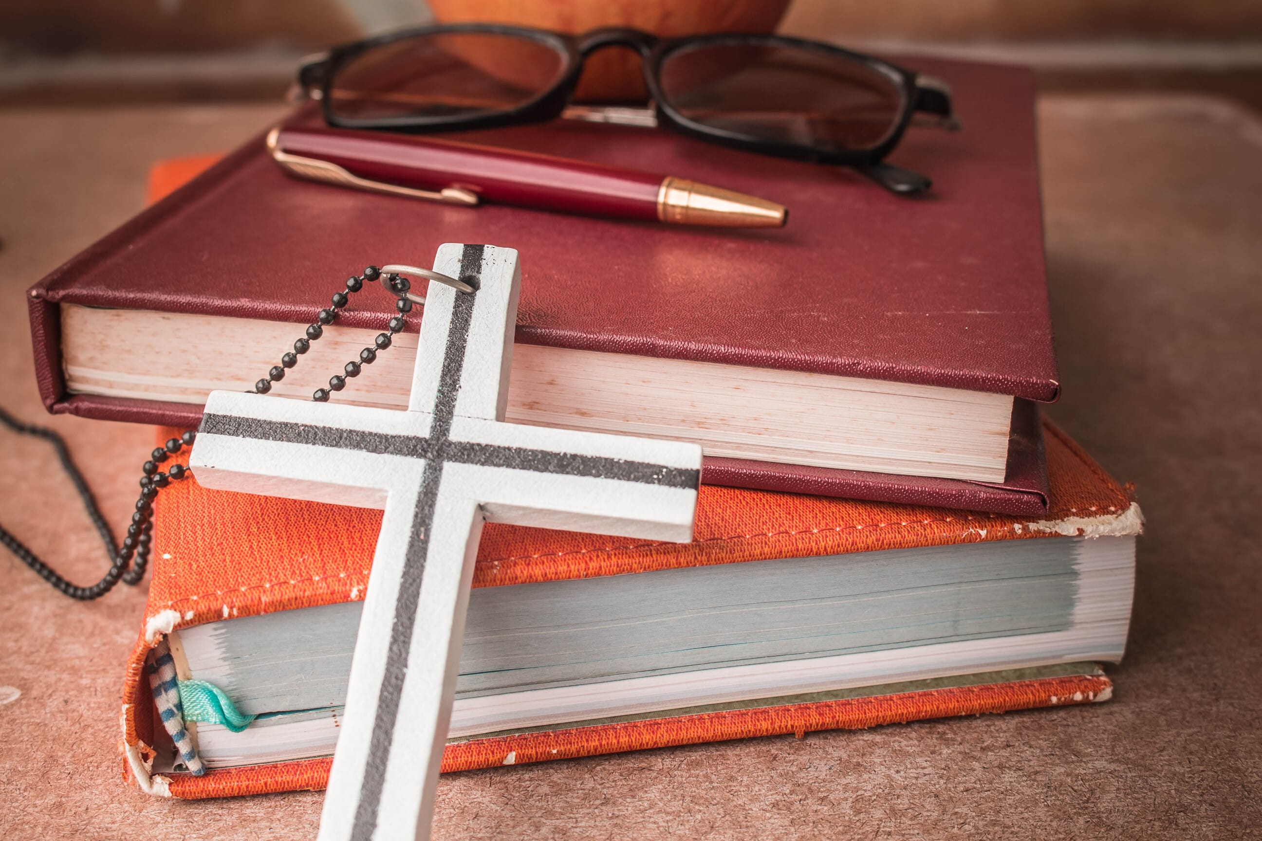 Stack of books with a cross