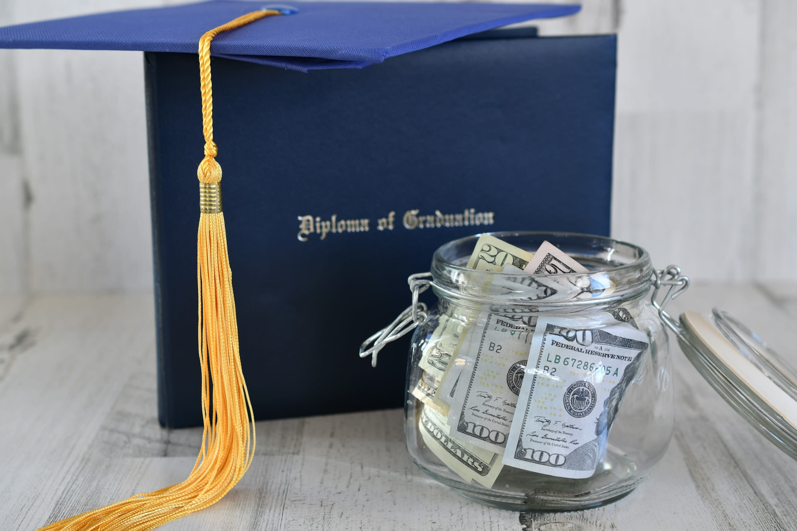Jar of money next to a diploma