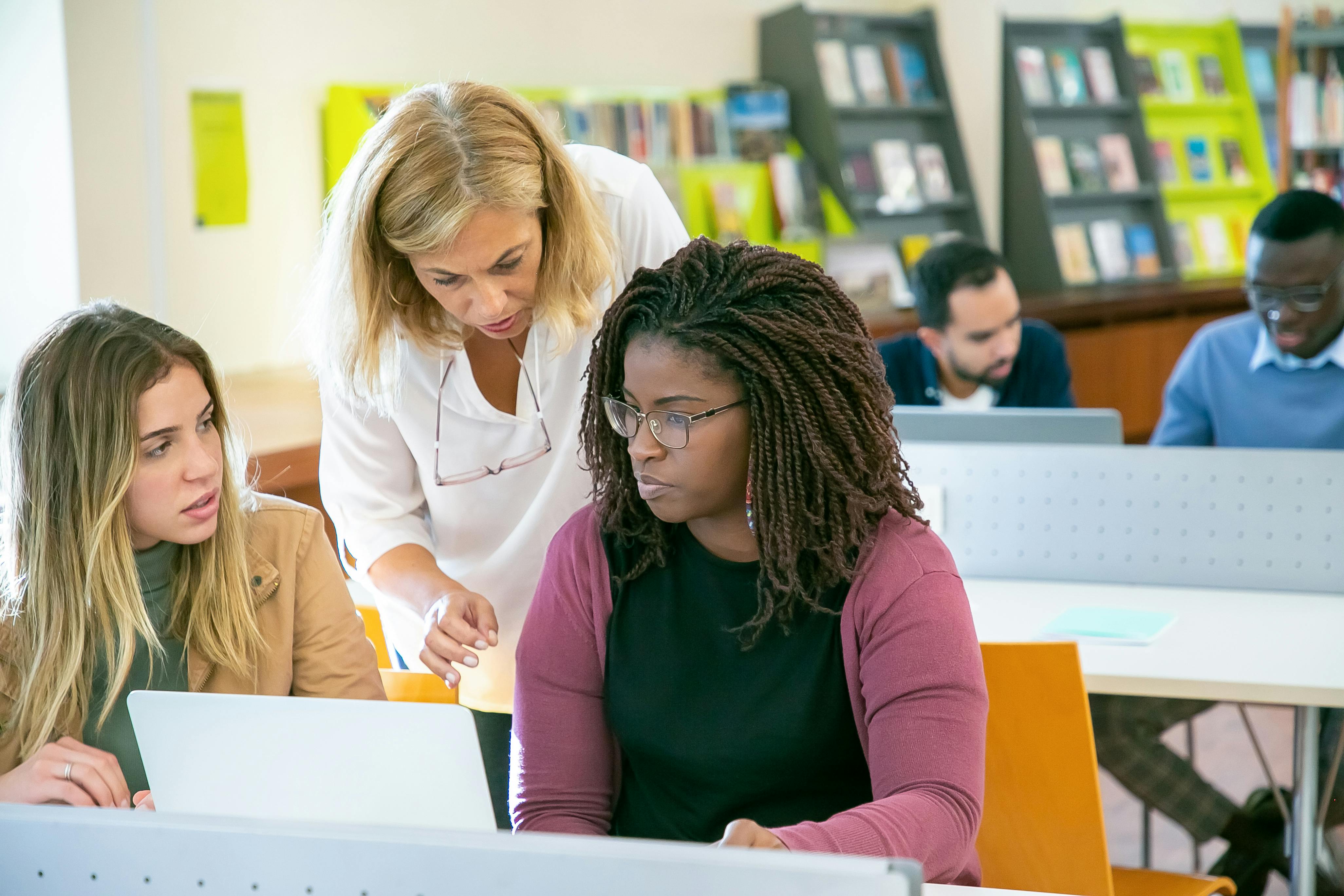 Two women listening to their manager while she offers advice