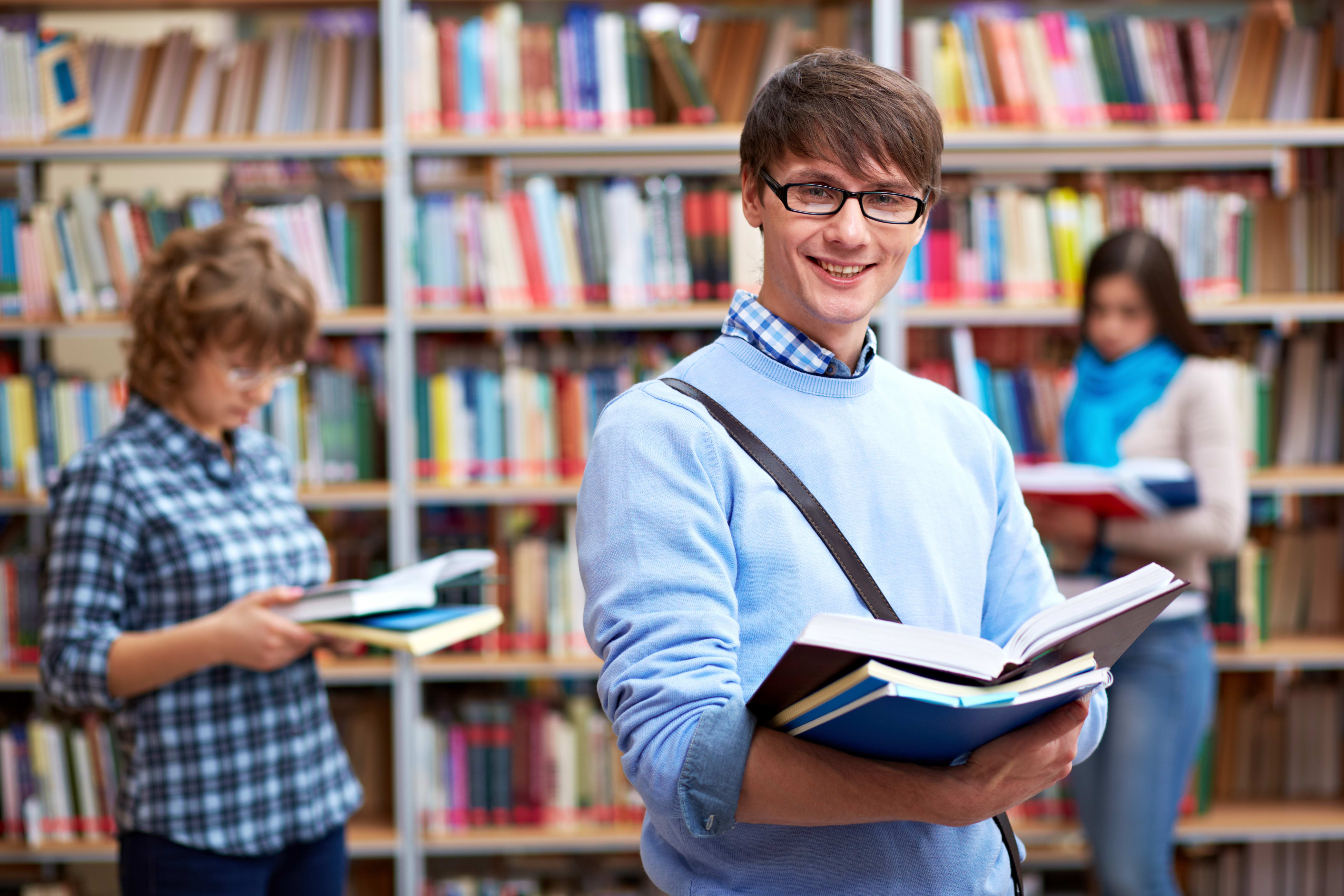 international business student standing in a college library