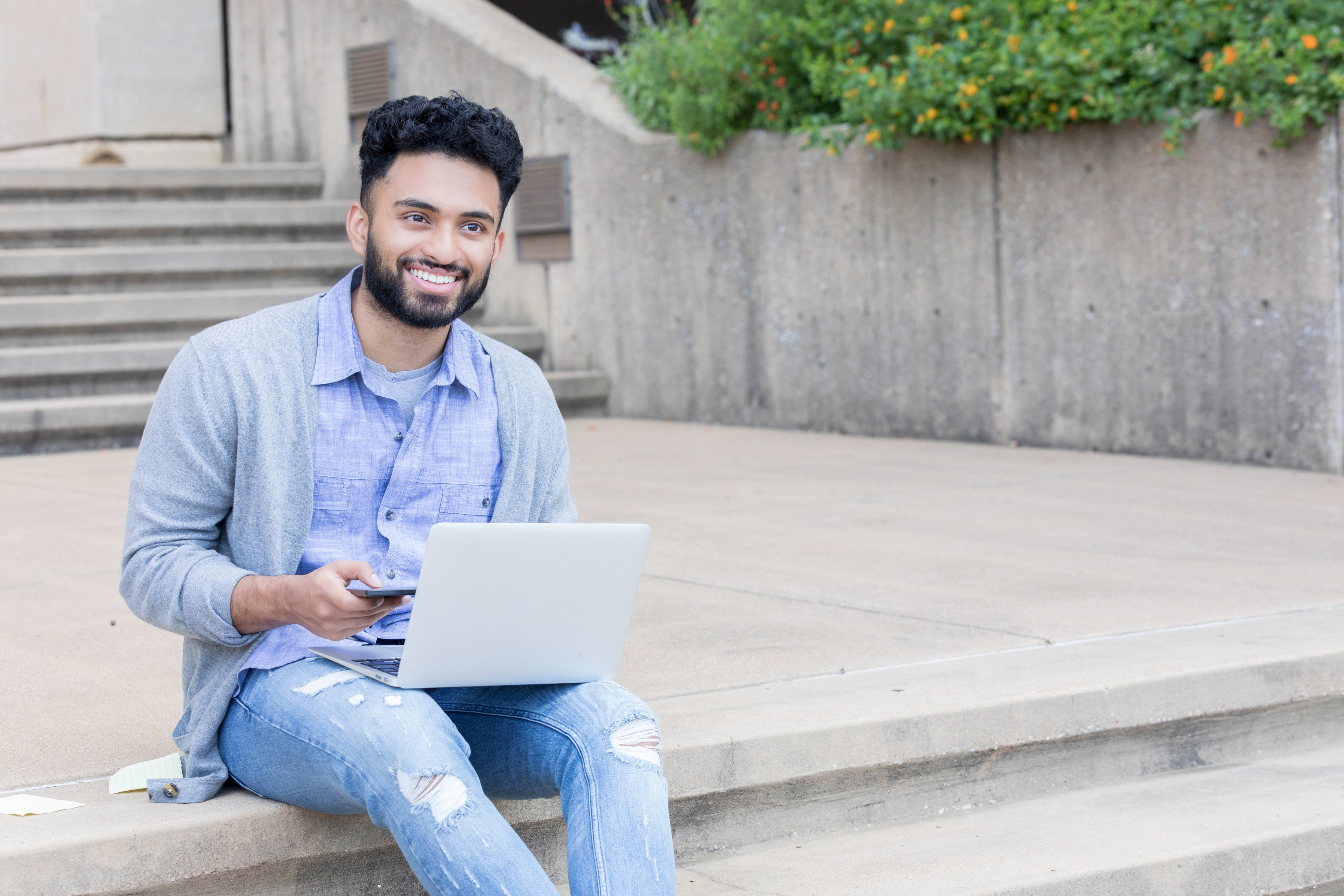 college student sitting outside on a college campus