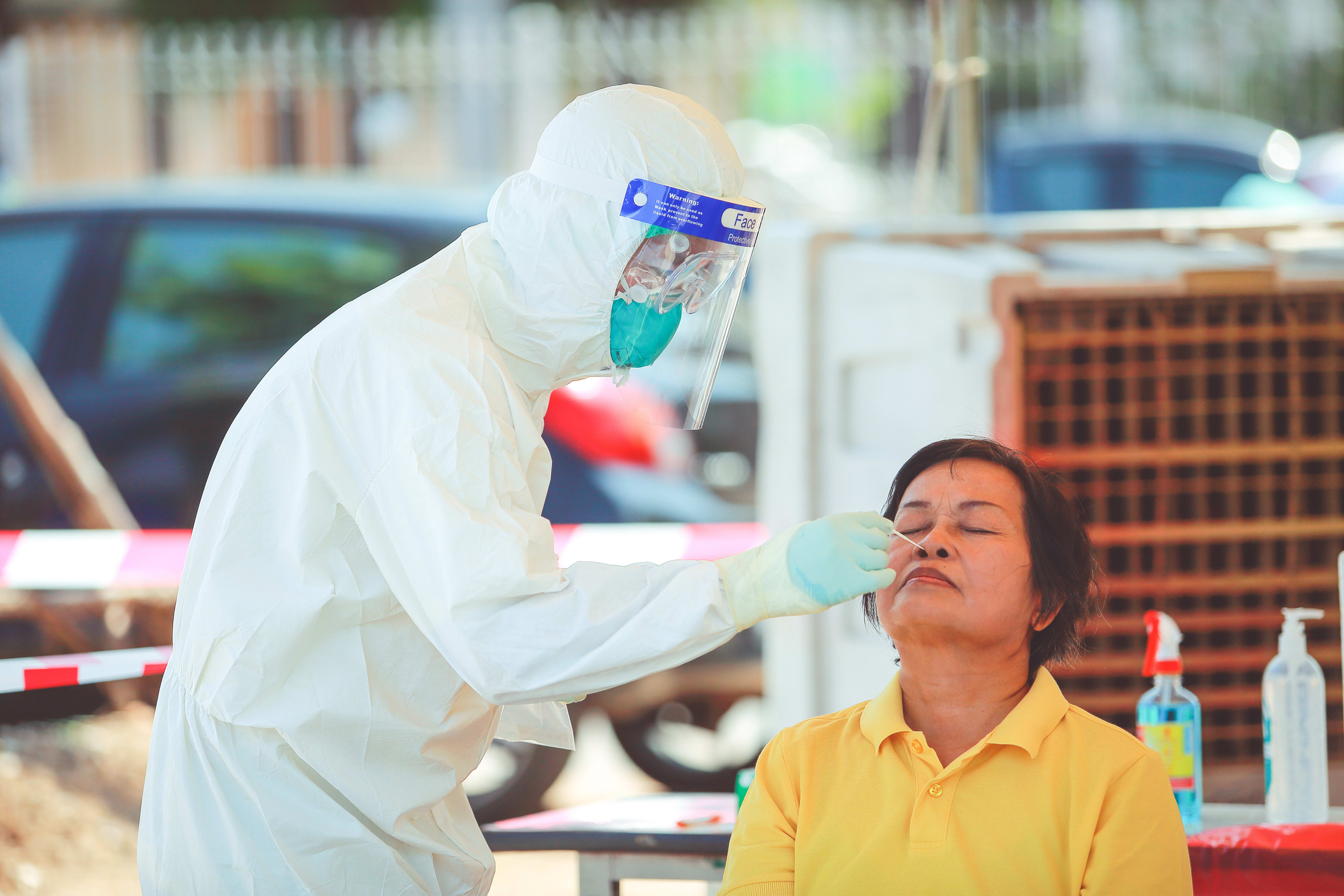 public health official administering a covid test