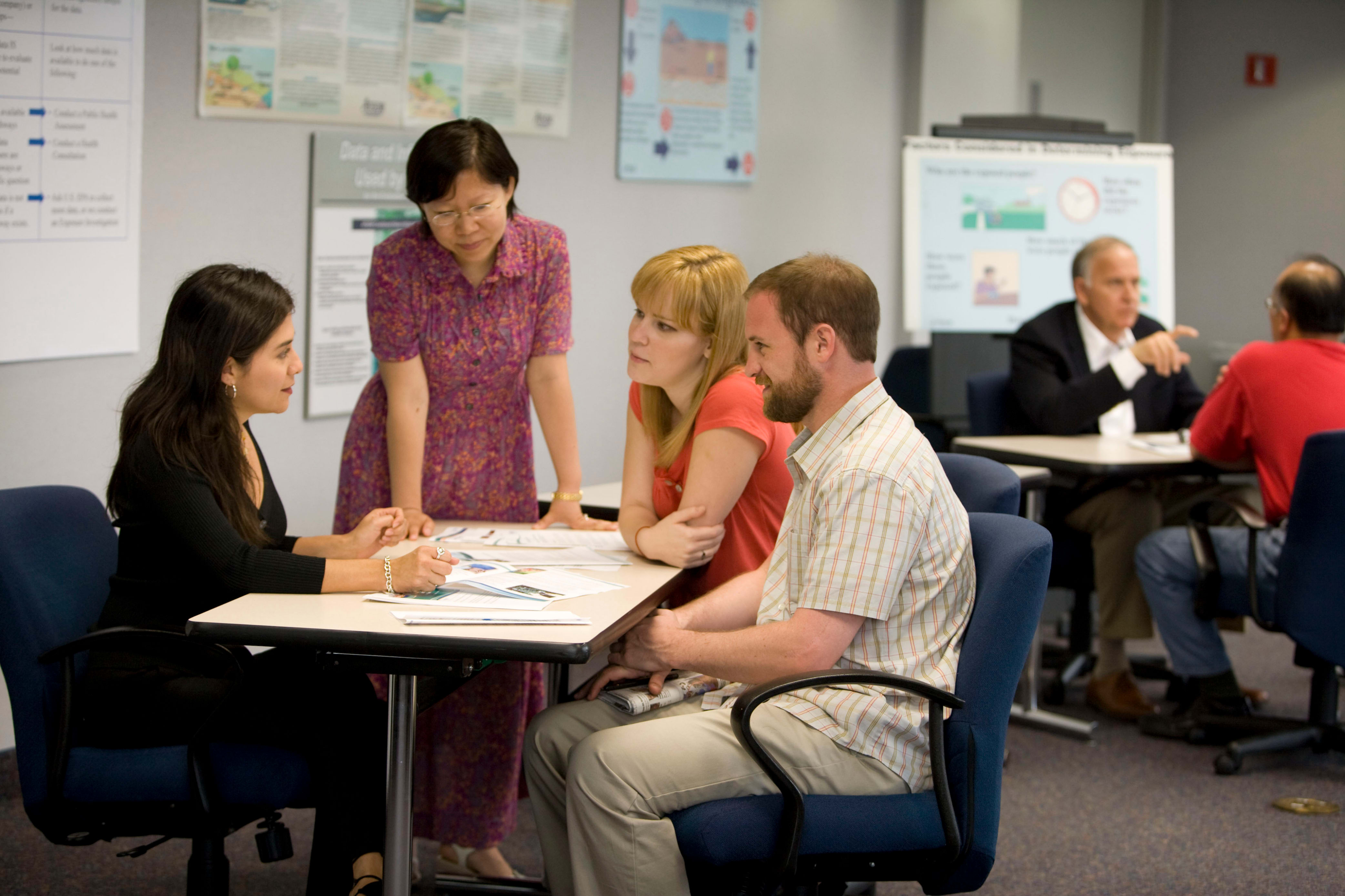 public health official sits down with citizens to discuss a public health plan