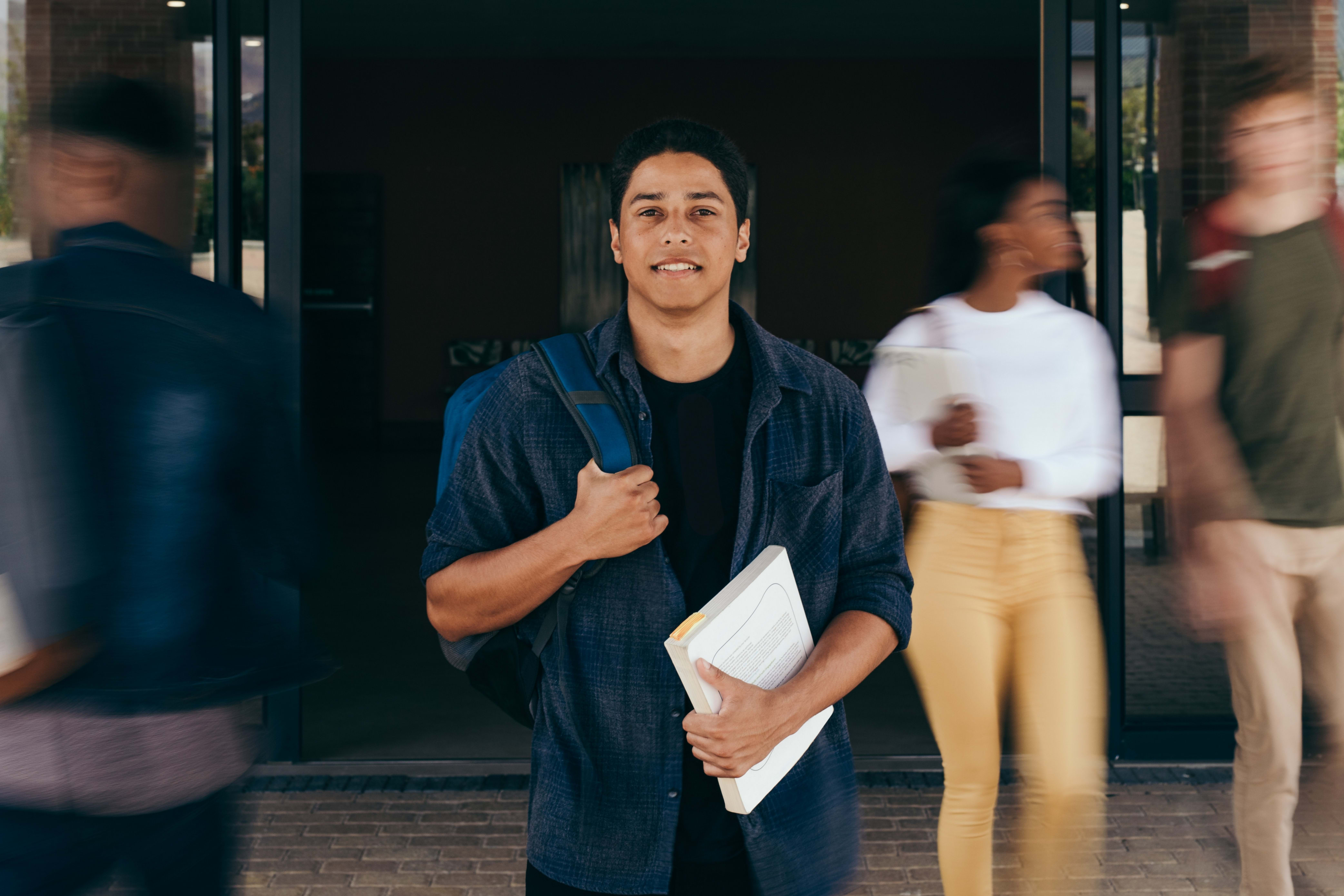 college student standing outside a building on campus