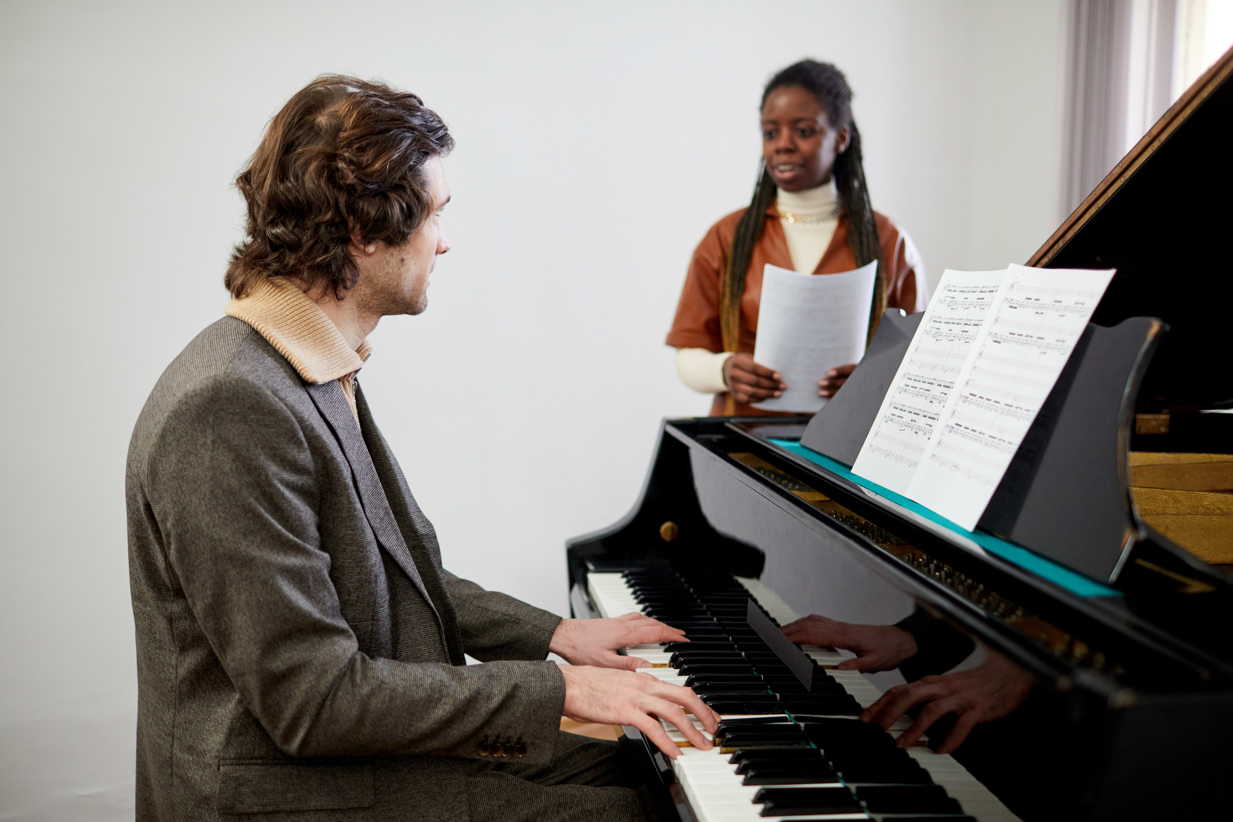 voice student singing with someone playing the piano
